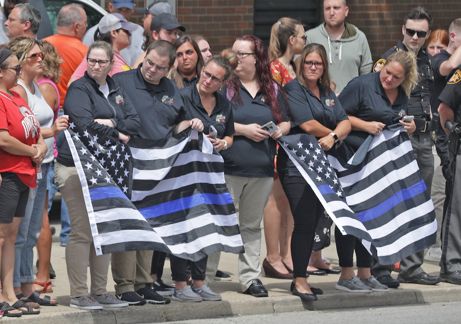 The Clark County community showed up to pay their respect to Deputy Matthew Yates who's body returned to Springfield in a Sheriff's Special Operations vehicle Monday afternoon. Yates, was escorted by a procession of law enforcement vehicles. Yates was shot Sunday while responding to a call at Harmony Estates mobile home park. BILL LACKEY/STAFF