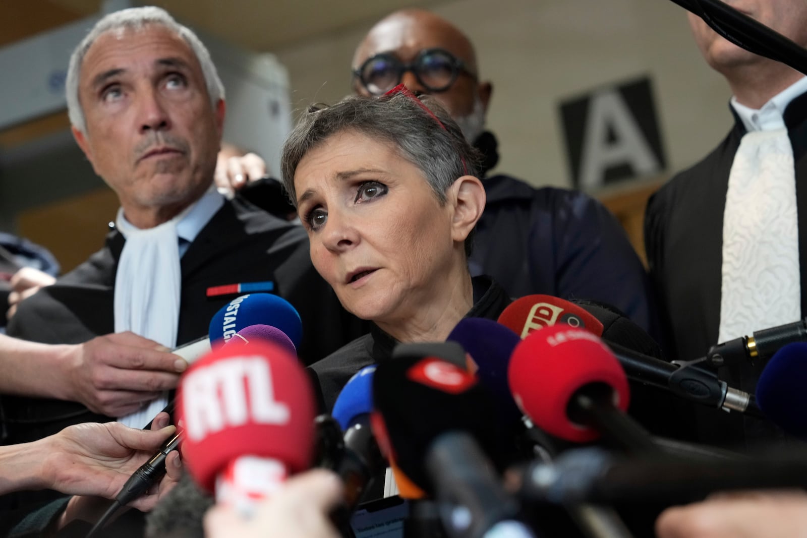 Lawyer Beatrice Zavarro talks to the media in the Avignon courthouse, southern France, Thursday, Dec. 19, 2024. (AP Photo/Lewis Joly)