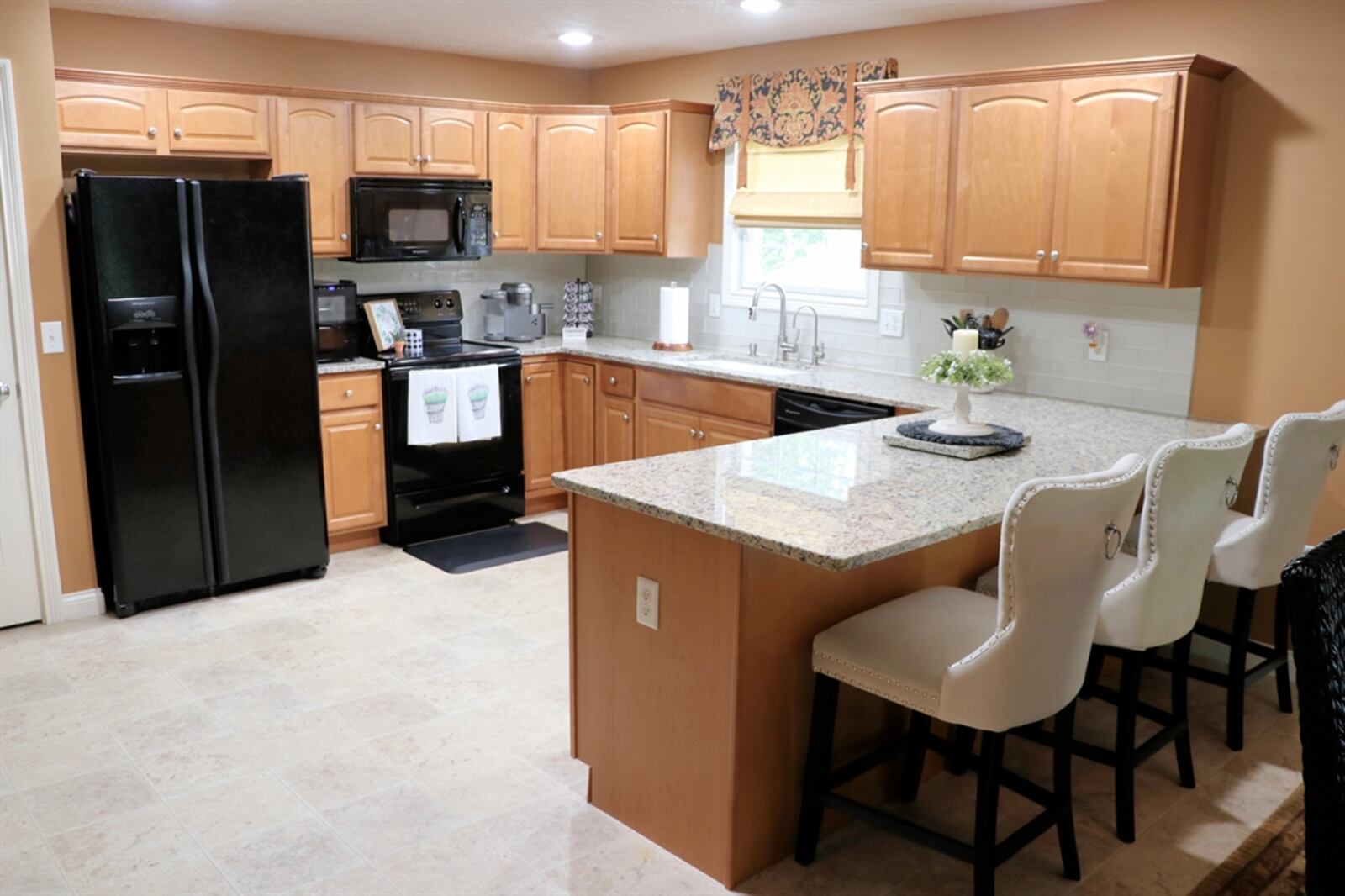 A peninsula counter divides the kitchen from the dining area and has an extended counter to allow for bar seating.