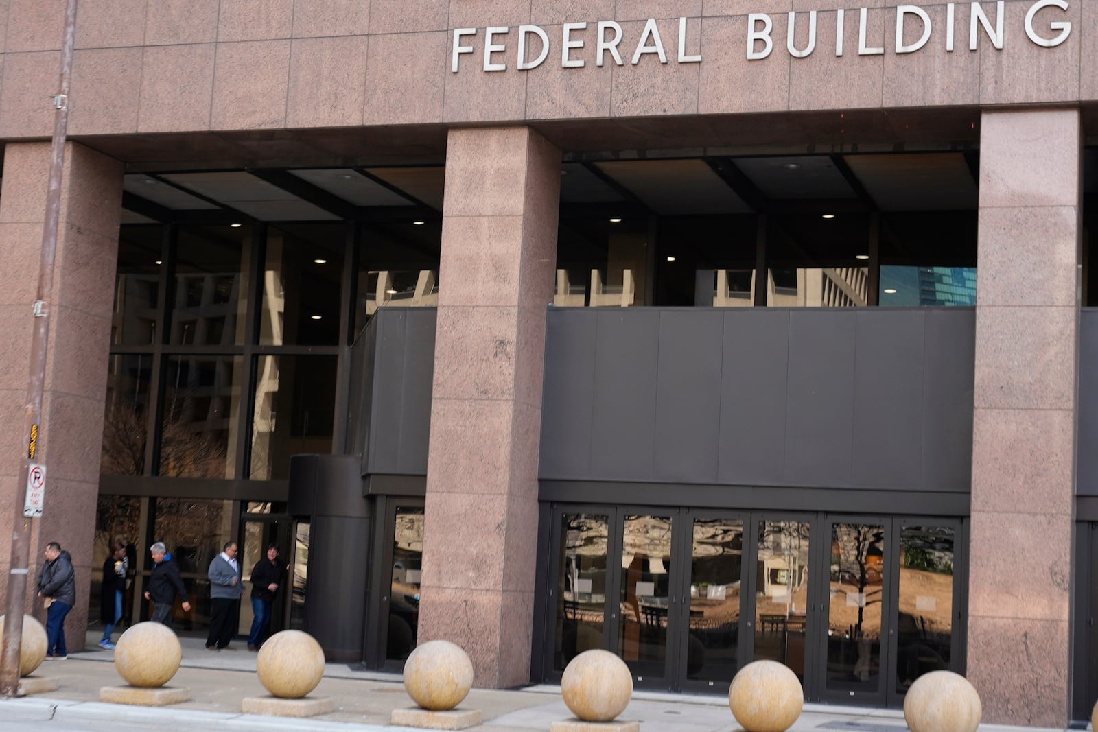 People enter the Earle Cabell Federal Building in downtown Dallas, Monday, Feb. 24, 2025. (AP Photo/LM Otero)