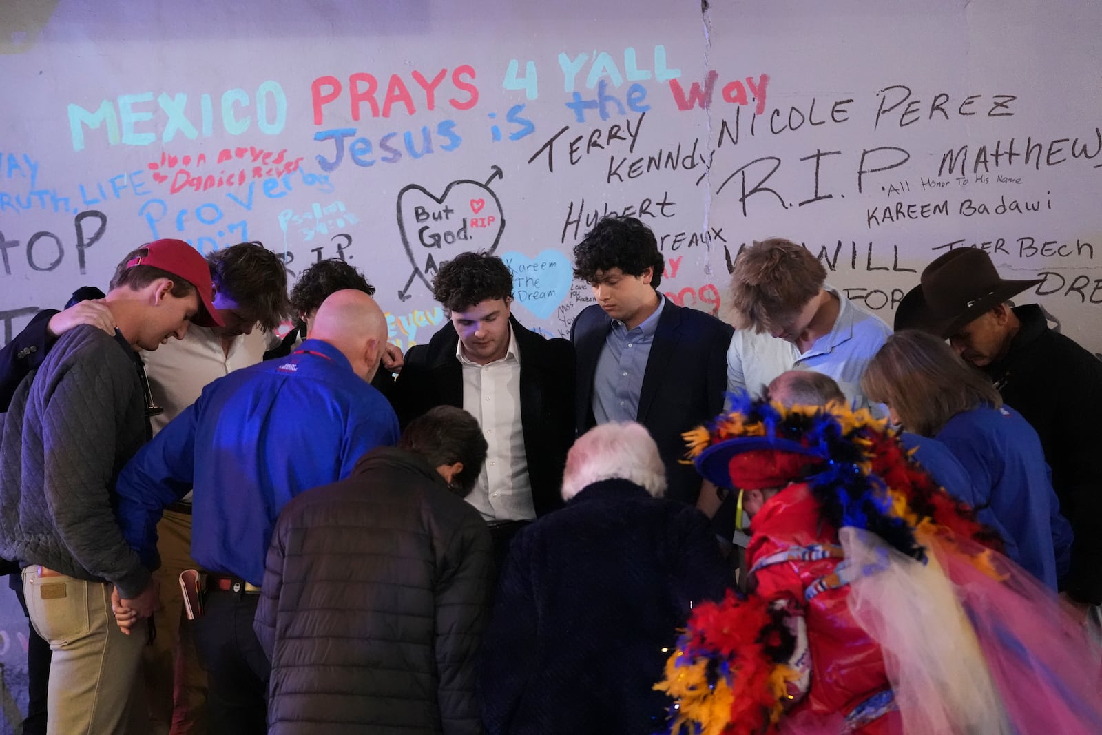 Friends of Kareem Badawi, a victim of the deadly truck attack on New Year's Day in New Orleans, pray at a memorial for victims after attending his funeral, Friday, Jan. 3, 2025. (AP Photo/Gerald Herbert)