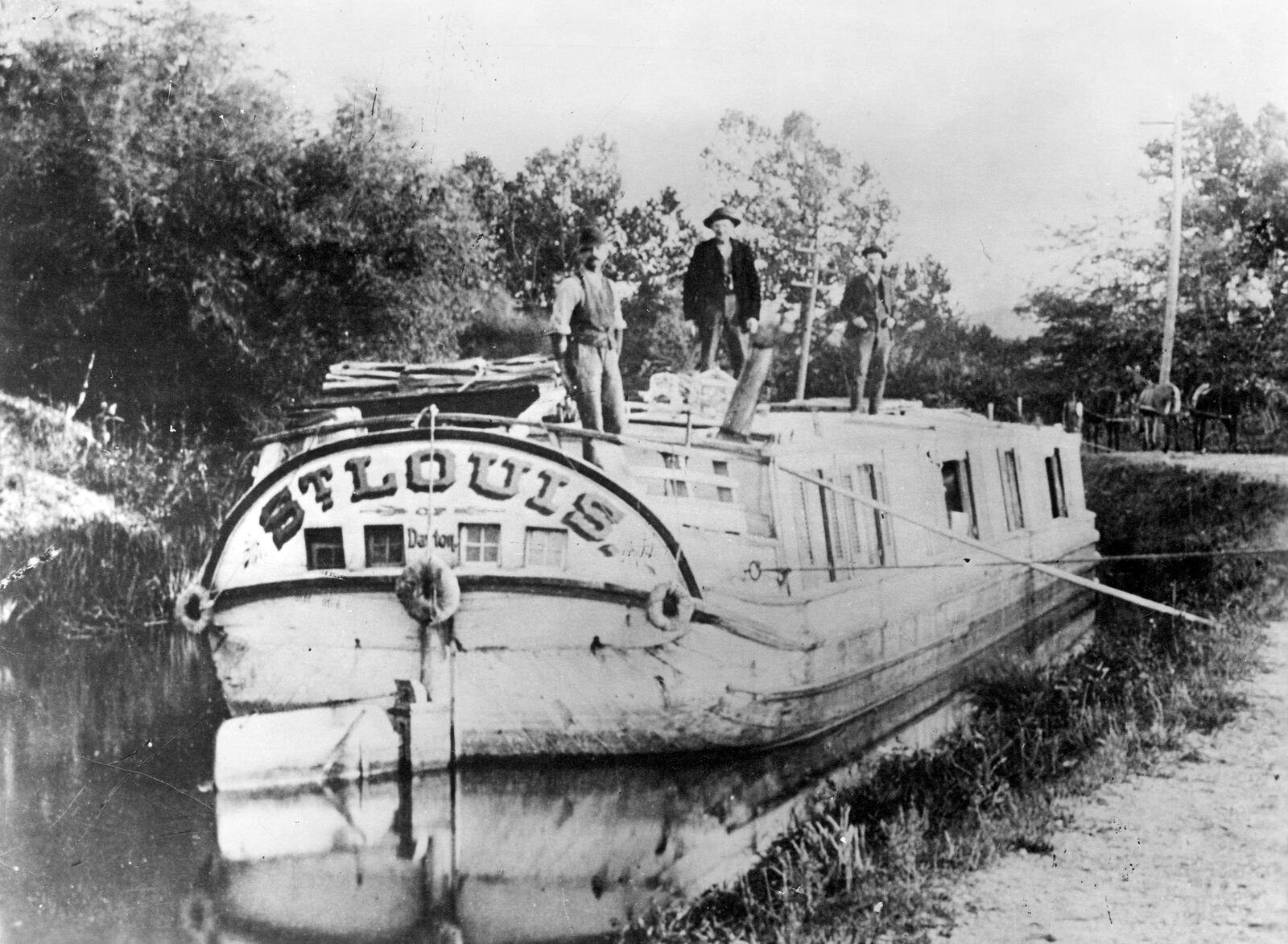 The "St. Louis of Dayton," a canal boat used to transport freight, travels the Miami and Erie Canal near Dayton. DAYTON METRO LIBRARY / MONTGOMERY COUNTY PICTURE FILE