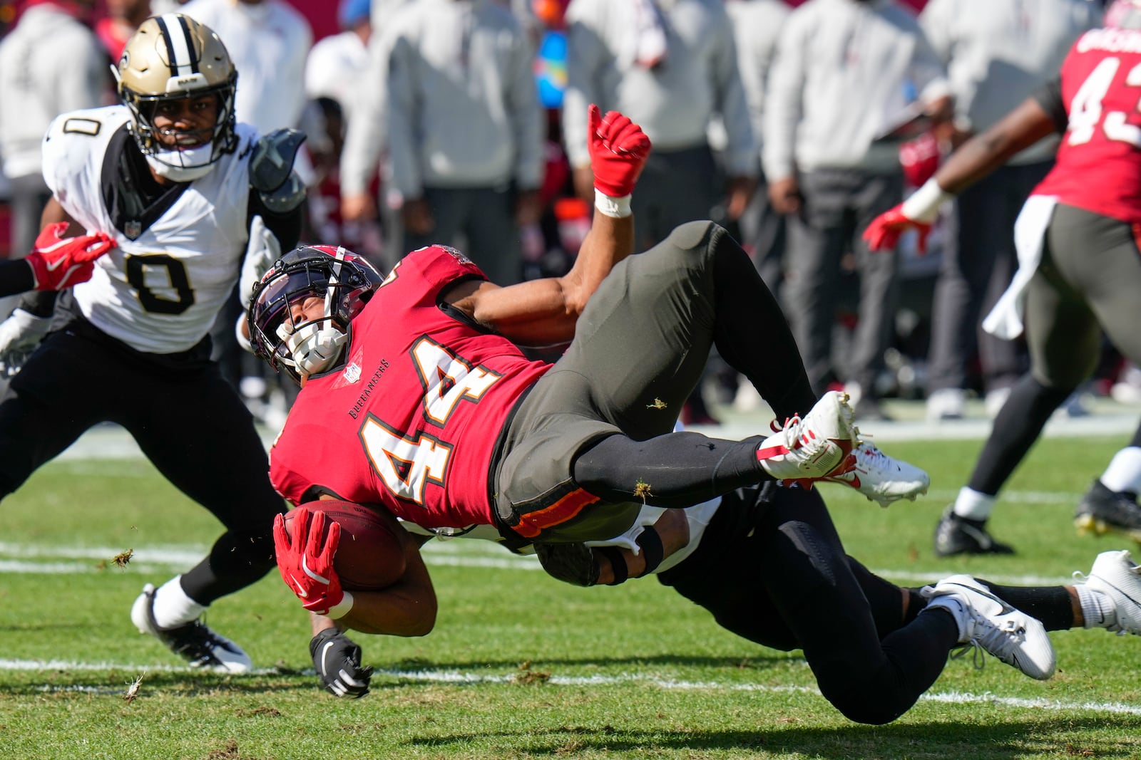 Tampa Bay Buccaneers Sean Tucker (44) is stopped by New Orleans Saints safety Millard Bradford on a kickoff return during the first half of an NFL football game Sunday, Jan. 5, 2025, in Tampa, Fla. (AP Photo/Chris O'Meara)