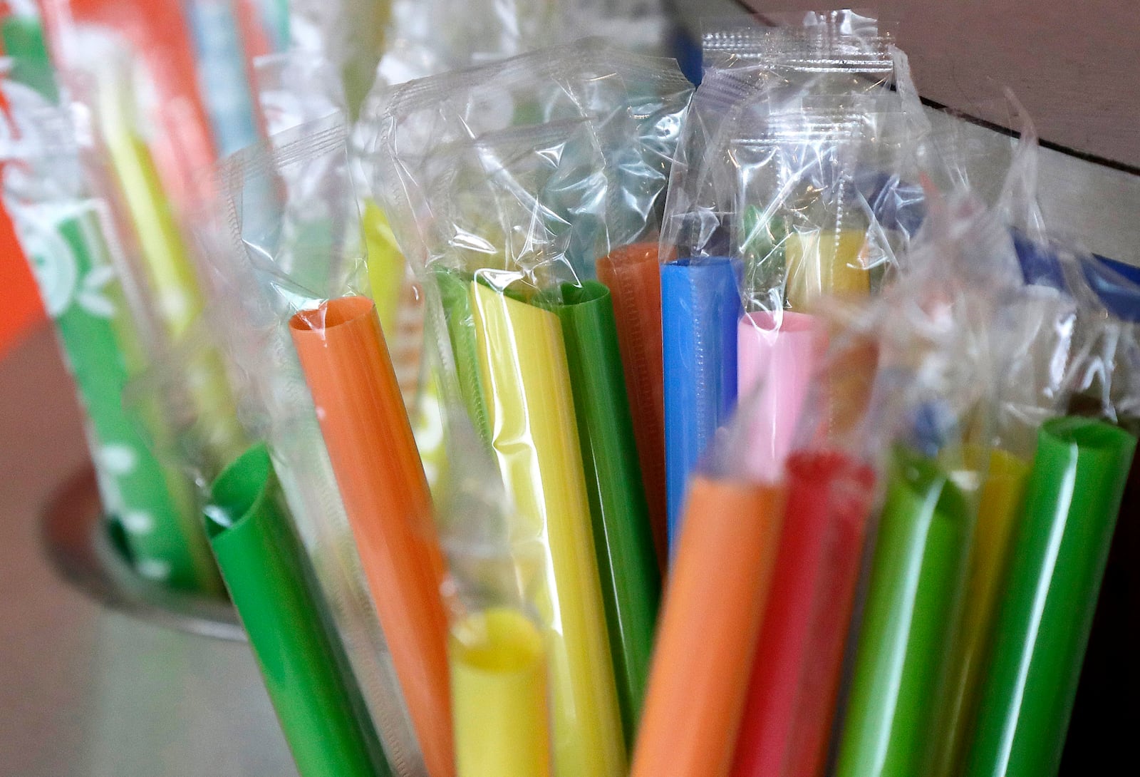 FILE - Wrapped plastic straws are seen at a bubble tea cafe in San Francisco, July 17, 2018. (AP Photo/Jeff Chiu, File)