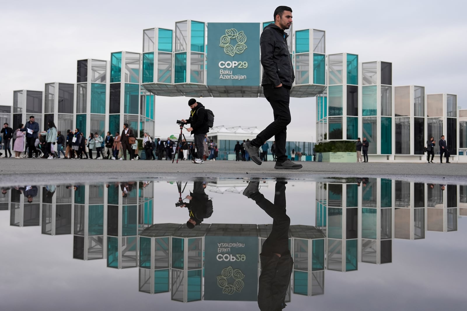 People arrive for the day at the COP29 U.N. Climate Summit, Tuesday, Nov. 19, 2024, in Baku, Azerbaijan. (AP Photo/Joshua A. Bickel)