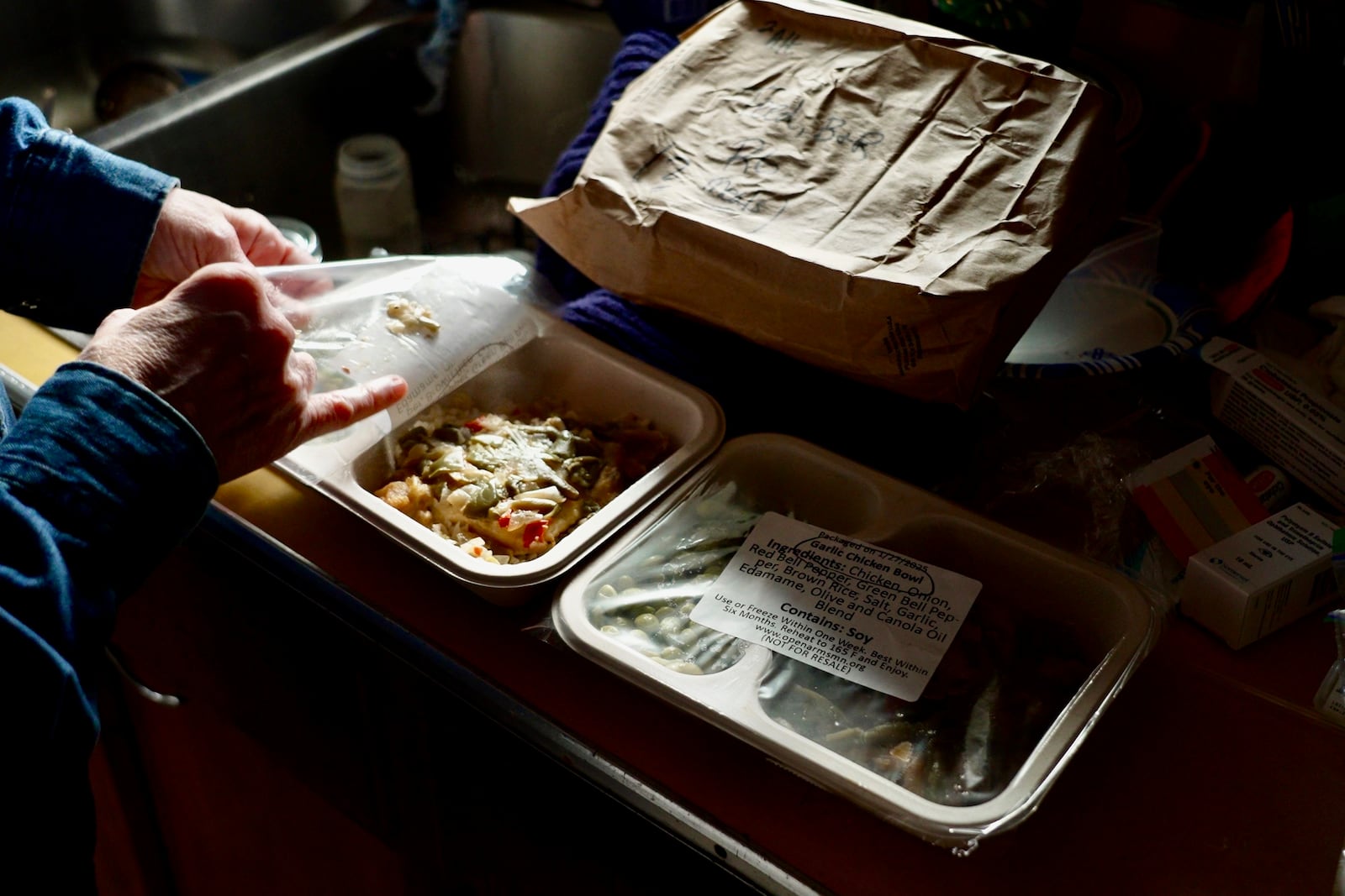 Barbara Teed unpacks a Meals on Wheels deliver for herself and her 30-year-old son Ryan, who has Down syndrome, on Wednesday, Jan. 29, 2025, in Bloomington, Minn. (AP photo/Mark Vancleave)