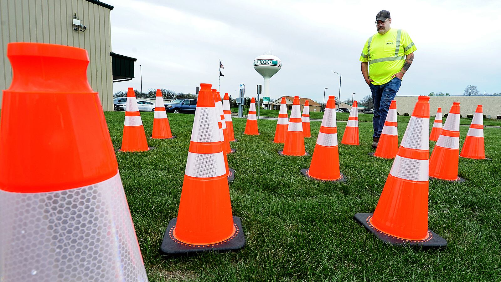 ODOT employee Ben Norrod walks through the 25 traffic cones Friday April 14, 2023 that represent the number of ODOT crews that had been stuck while working on Ohio roadways to that point of 2023. Norrad, who is married and has 5 children, fears for his life while working on the roads. MARSHALL GORBY\STAFF