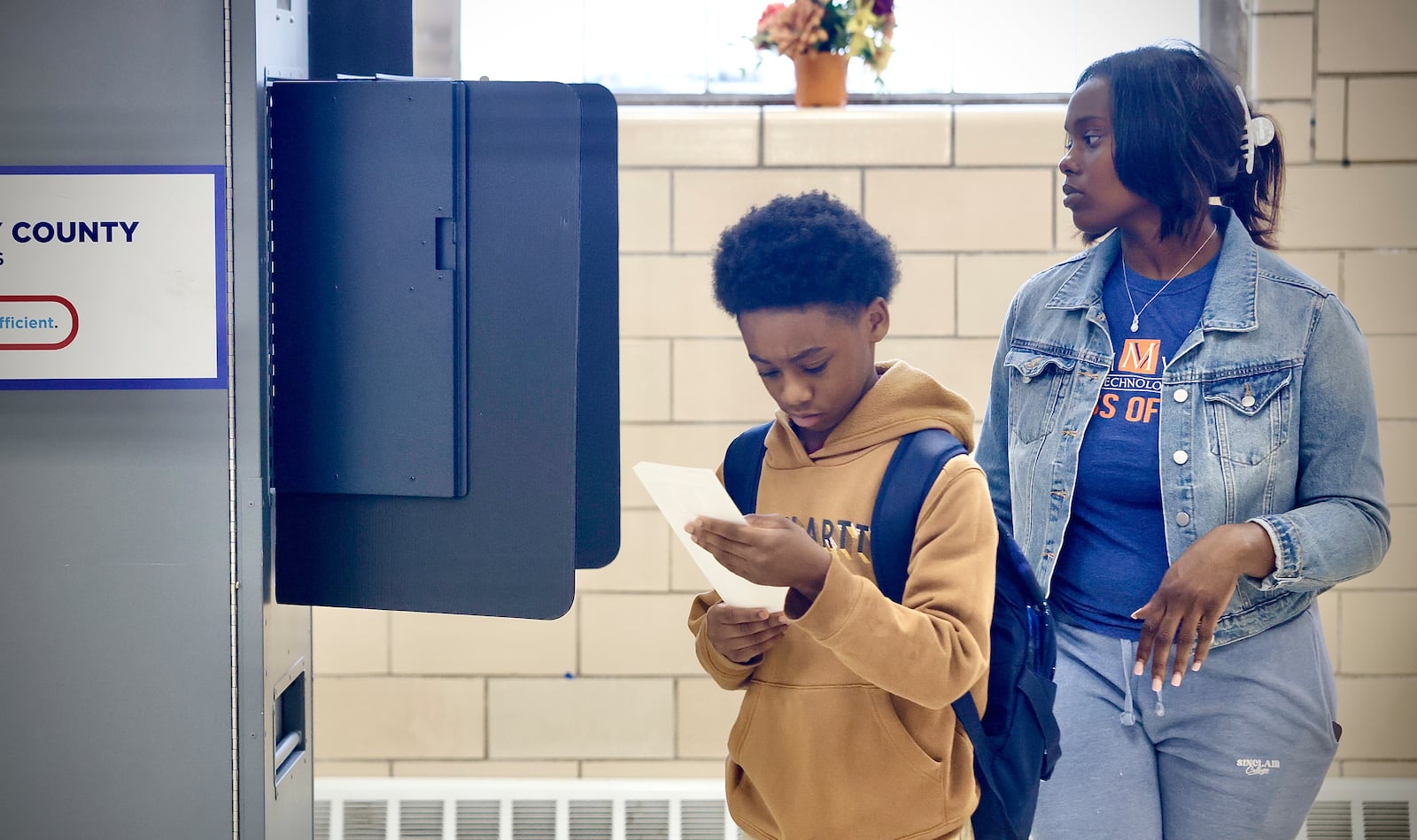 Emilio Jackson, 9, looks over the ballot of his mother, Erionna Johnson, after she voted at the Fairview United Methodist Church on Tuesday, Nov. 5, 2024. Johnson said her son likes coming with her to vote, and she also noted how it’s important for him to understand the need to vote. MARSHALL GORBY / STAFF