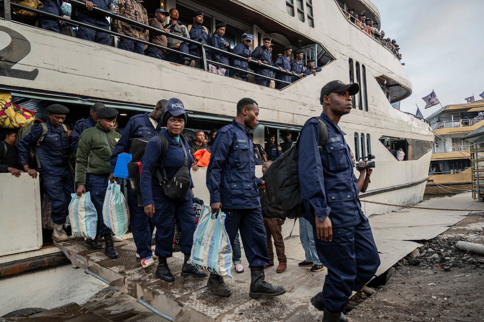 Former members of the Armed Forces of the Democratic Republic of Congo (FARDC) and police officers who allegedly surrendered to M23 rebels arrive in Goma, Congo, Sunday, Feb. 23, 2025. (AP Photo/Moses Sawasawa)