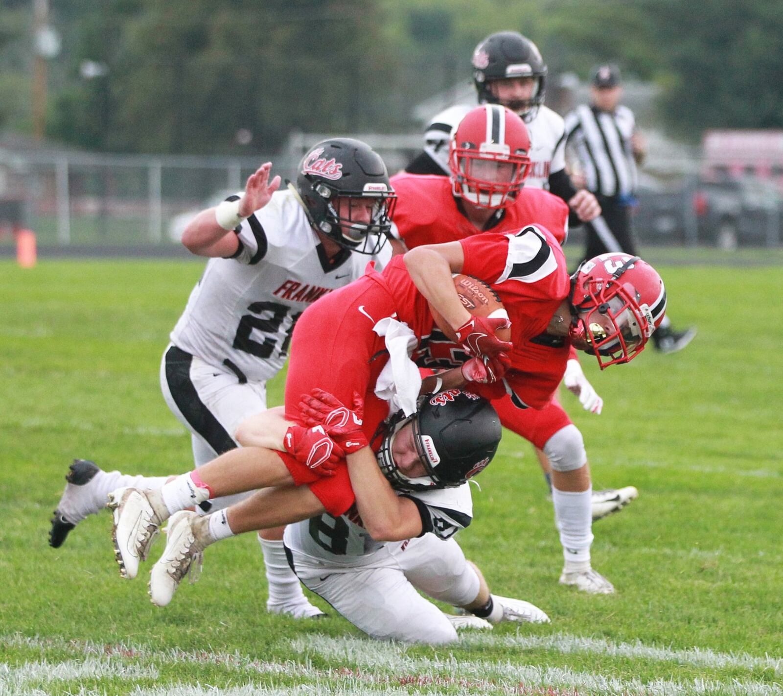 Zach Johnson of Franklin (bottom) makes a stop. Franklin defeated host Madison 42-6 in a Week 1 high school football opener on Friday, Aug. 30, 2019. MARC PENDLETON / STAFF