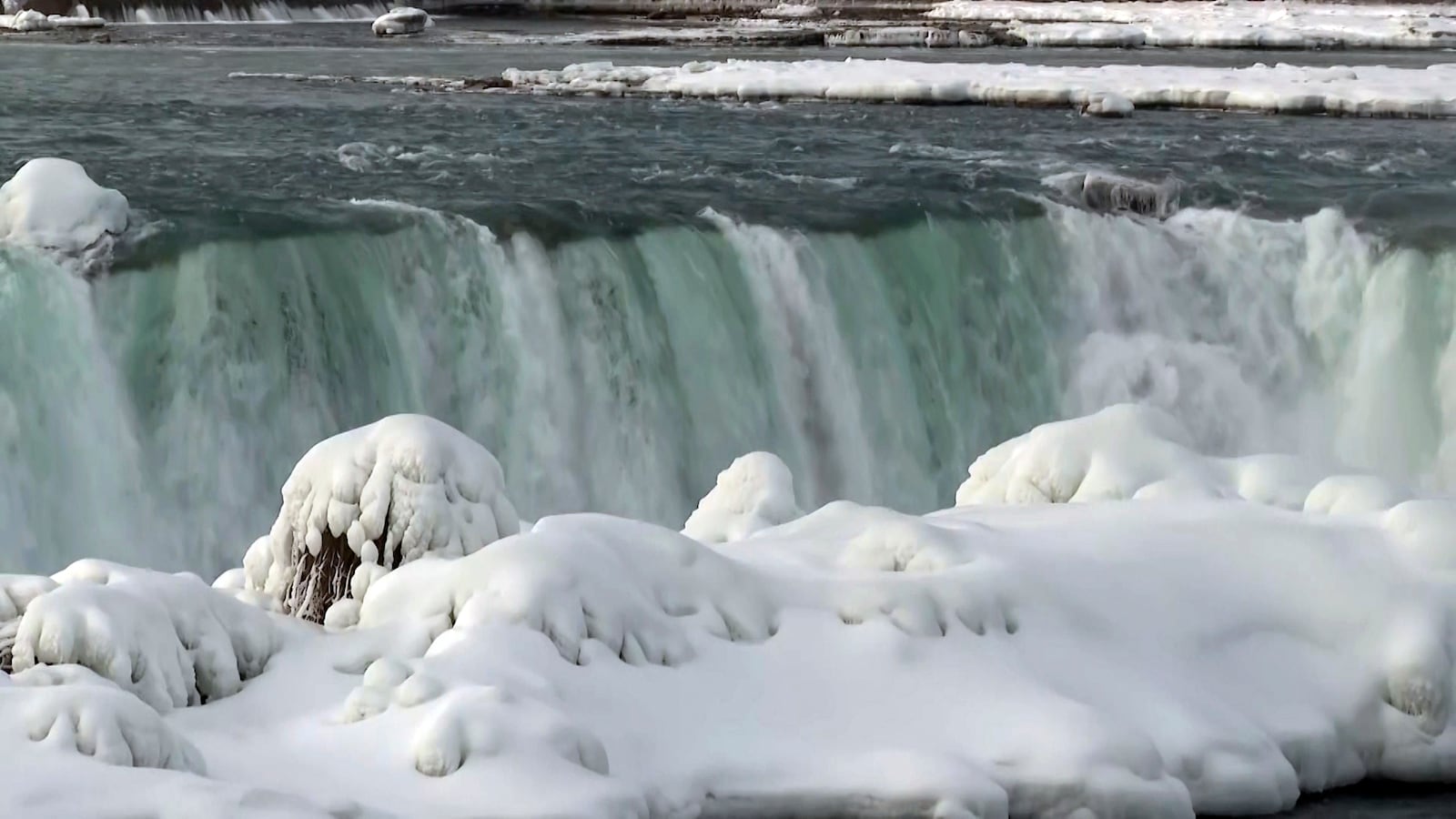 Snow and ice accumulate around the top of Niagara Falls Wednesday, Feb. 12, 2025, in Niagara Falls, N.Y. (AP Photo/Mike Householder)