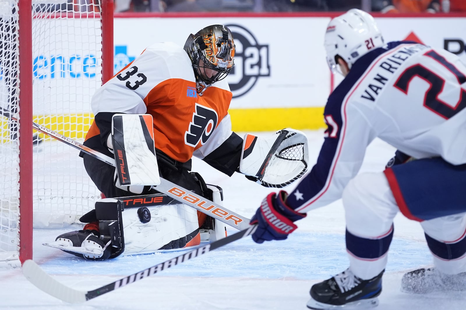 Philadelphia Flyers' Samuel Ersson, left, blocks a shot as Columbus Blue Jackets' James van Riemsdyk skates in during the first period of an NHL hockey game, Saturday, Dec. 21, 2024, in Philadelphia. (AP Photo/Matt Slocum)