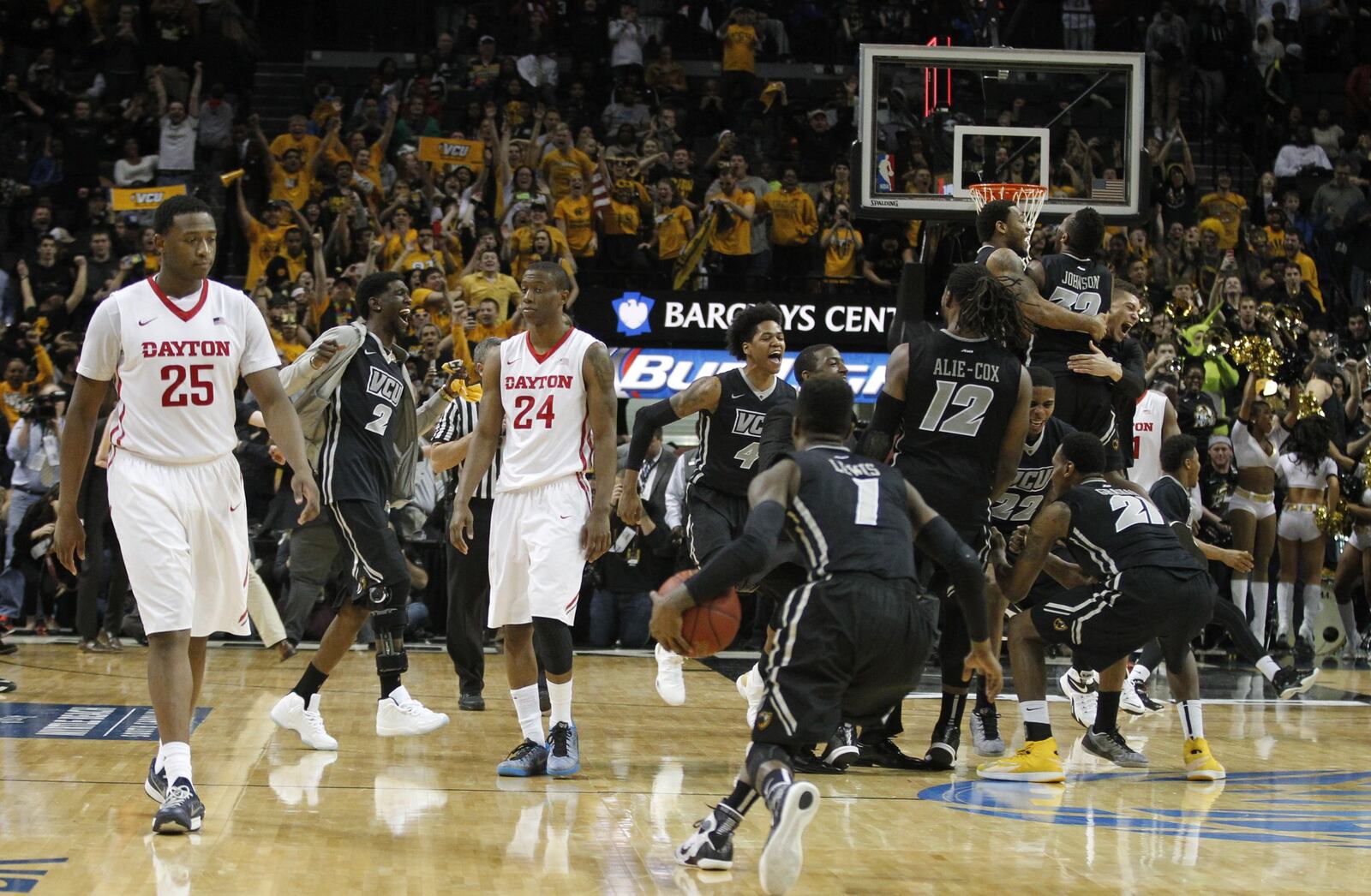 Dayton’s Kendall Pollard, left, and Jordan Sibert leave the court as Virginia Commonwealth celebrates a victory on Sunday, March 15, 2015, at the Barclays Center in Brooklyn, N.Y. David Jablonski/Staff