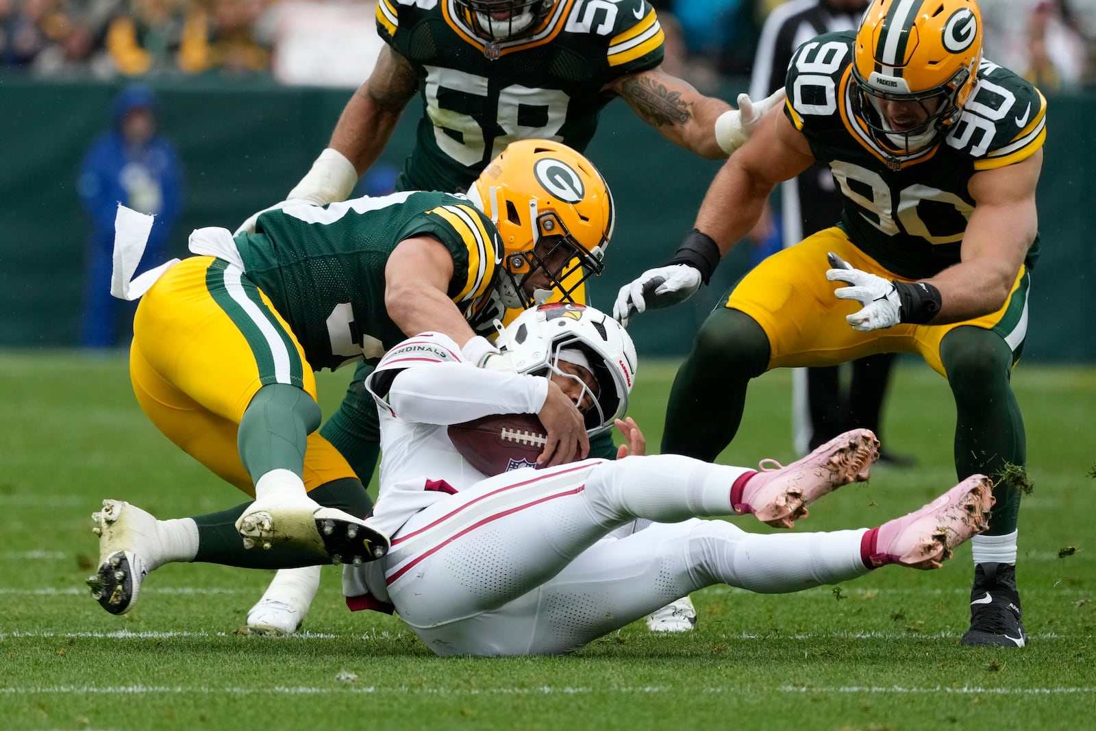 Green Bay Packers safety Evan Williams (33) stops Arizona Cardinals quarterback Kyler Murray during the first half of an NFL football game, Sunday, Oct. 13, 2024, in Green Bay. (AP Photo/Morry Gash)