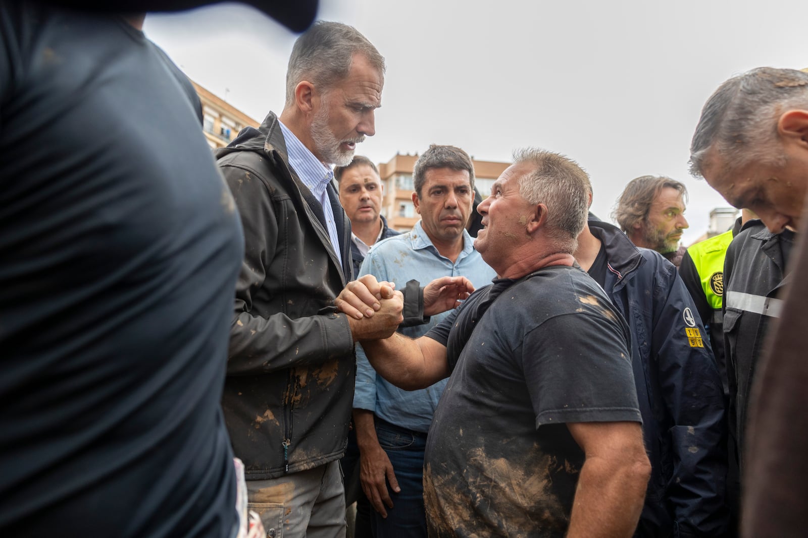 Spain's King Felipe VI speaks with people amidst angry Spanish flood survivors in Paiporta, near Valencia, Spain, Sunday Nov. 3, 2024. (AP Photo/David Melero)