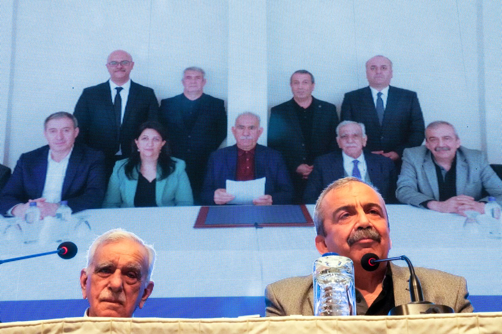 FILE - Pro-Kurdish Peoples' Equality and Democracy Party, or DEM, delegation members release an statement from the jailed leader of the rebel Kurdistan Workers' Party, or PKK, Abdullah Ocalan, center at the background photo, in Istanbul, Turkey, Thursday, Feb. 27, 2025. (AP Photo/Khalil Hamra, File)