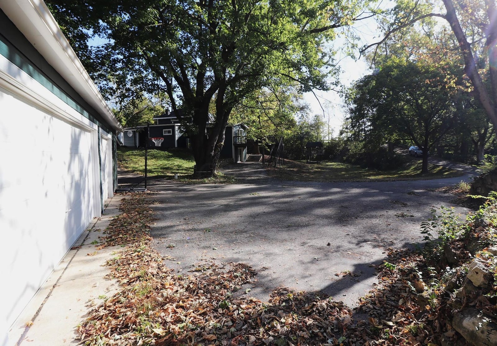 The home has a three car detached garage connected by an asphalt driveway with turnaround