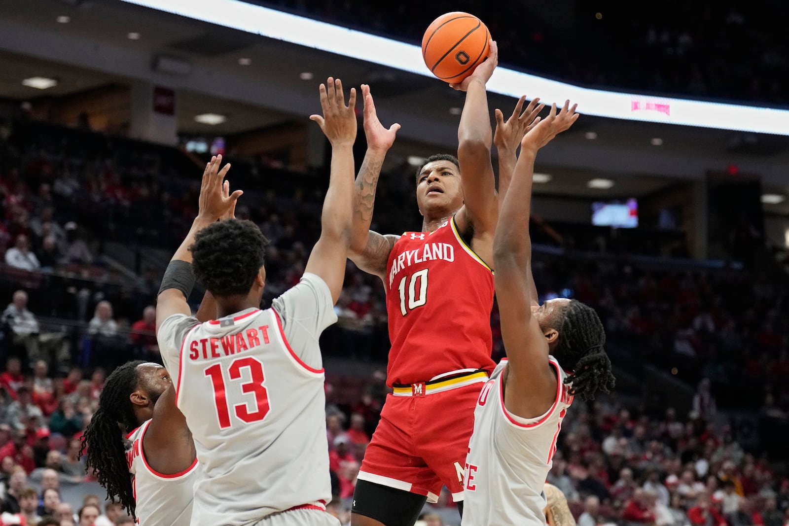 Maryland forward Julian Reese (10) looks to shoot between Ohio State forward Sean Stewart (13) and guard Evan Mahaffey, right, in the first half of an NCAA college basketball game Thursday, Feb. 6, 2025, in Columbus, Ohio. (AP Photo/Sue Ogrocki)