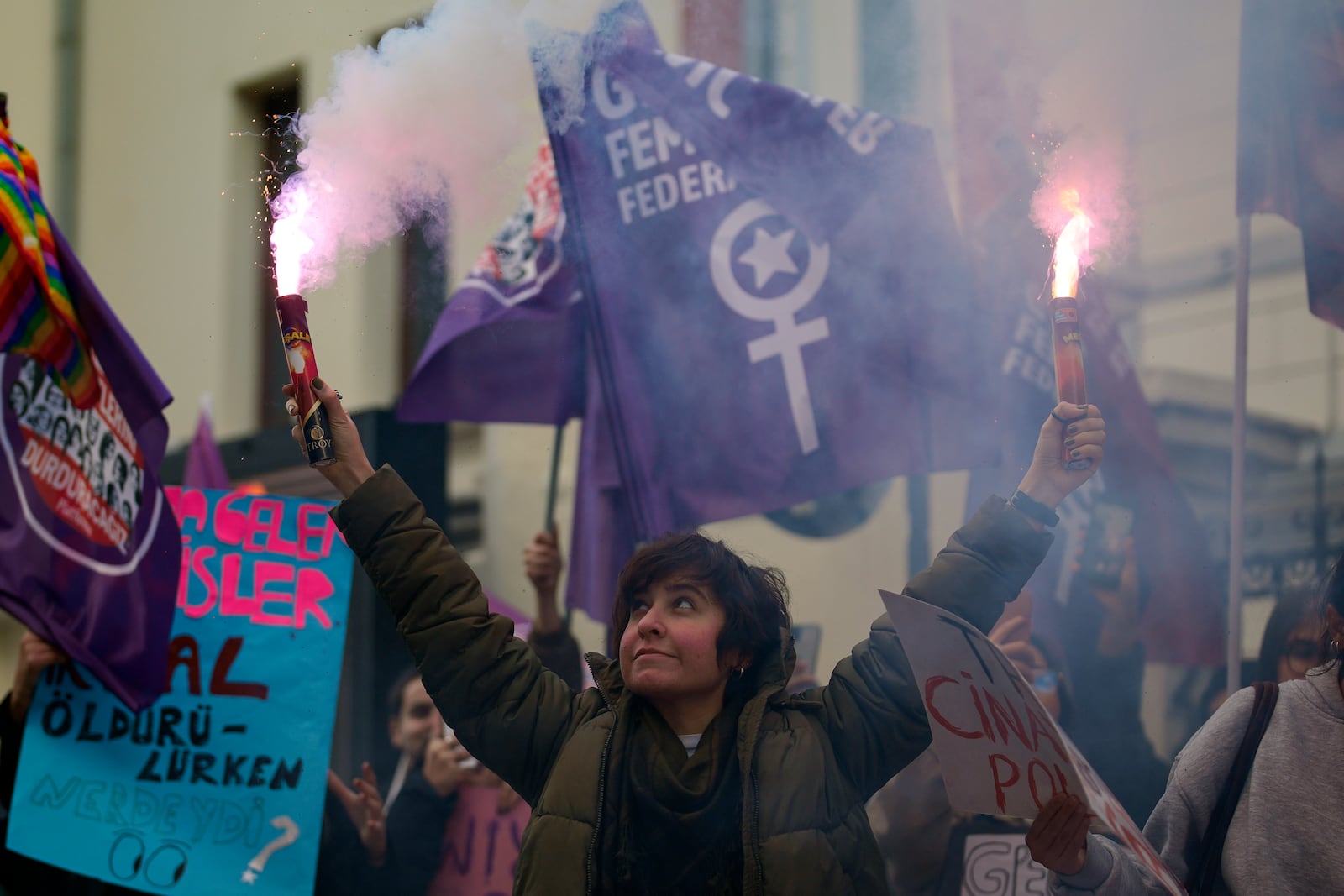 A woman holds a torch during a rally marking the upcoming International Day for the Elimination of Violence Against Women, in Istanbul,Turkey, Sunday, Nov. 24, 2024. (AP Photo/Emrah Gurel)