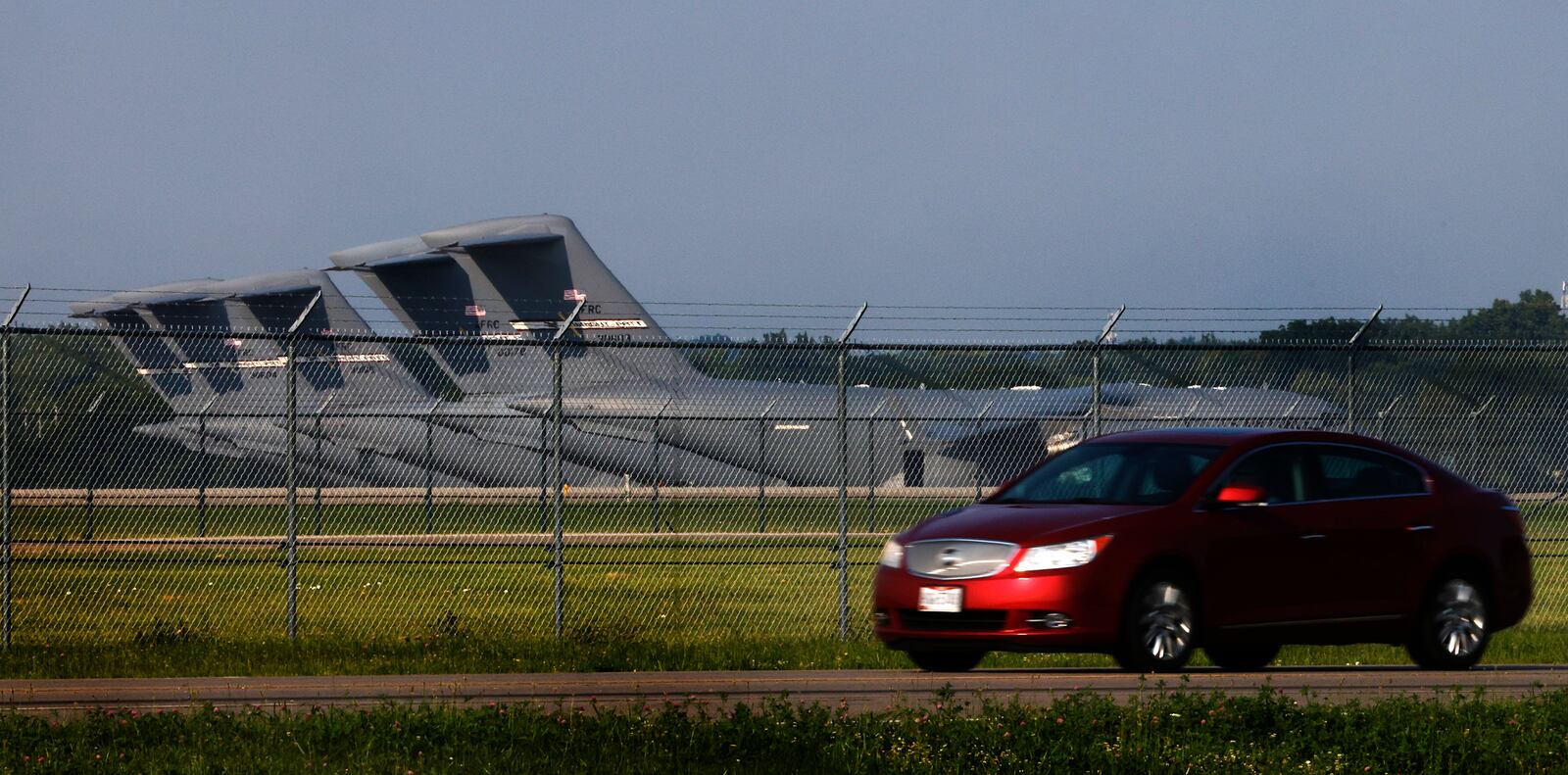 A car drives by Wright Patterson Air Force Base Wednesday, July 24, 2024. U.S. Senator Sherrod Brown has introduced legislation to protect U.S. national security facilities and critical infrastructure by prohibiting Internet-connected vehicles produced in or controlled by China and other adversaries near U.S. military bases and other federal installations. MARSHALL GORBY\STAFF