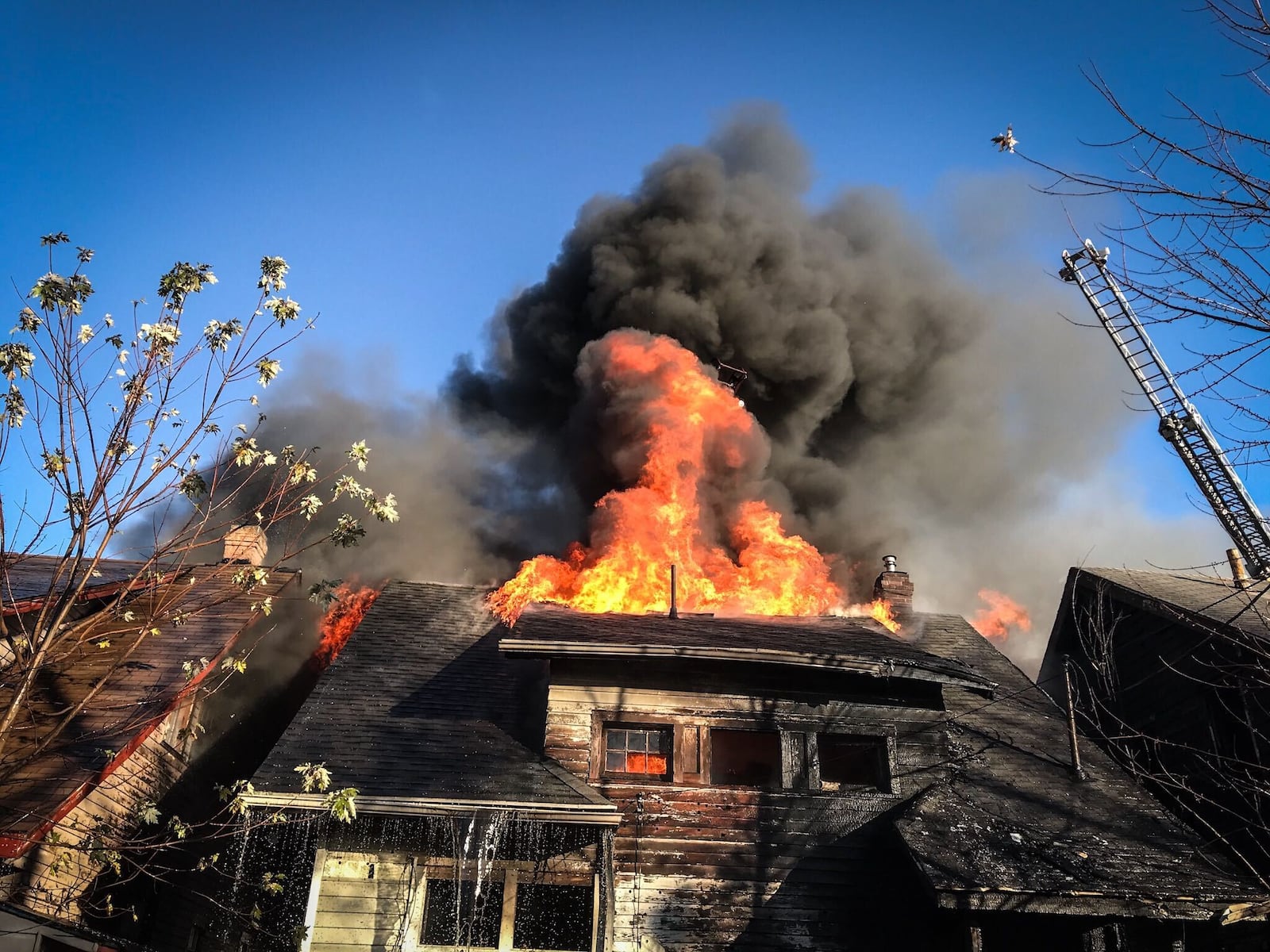 Heavy smoke and flames were coming from a vacant house in the 200 block of South Findlay Street in Dayton on Nov. 17, 2020. JIM NOELKER / STAFF