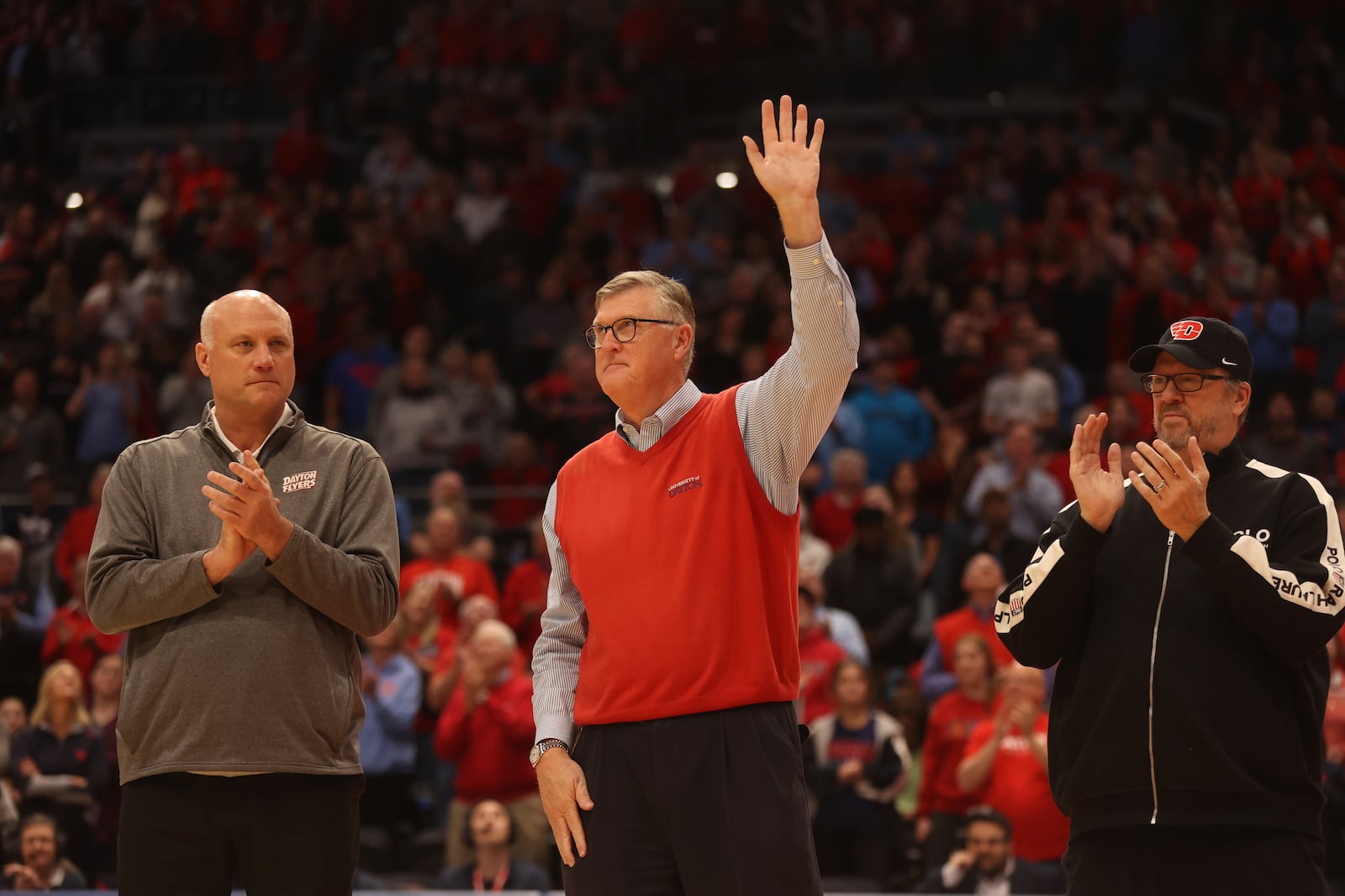 Ed Young waves to the crowd during a ceremony honoring members of Dayton's 1984 Elite Eight team at halftime of a game against Grambling State on Saturday, Dec. 2, 2023, at UD Arena. David Jablonski/Staff