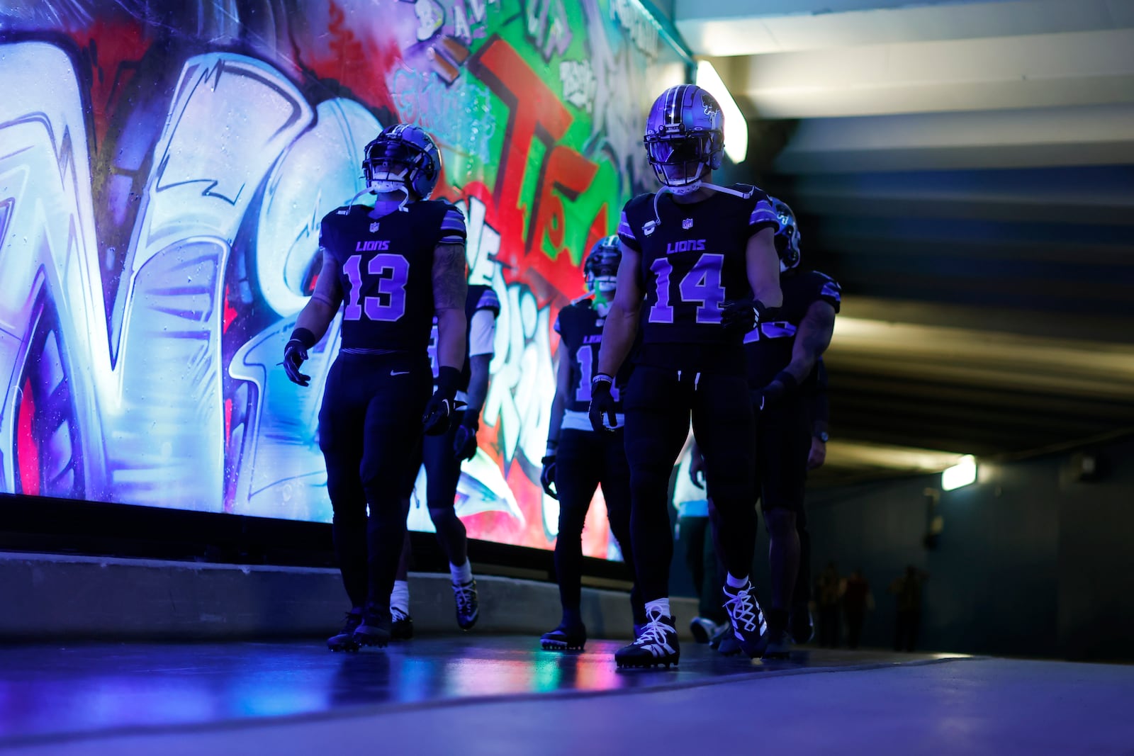 Detroit Lions running back Craig Reynolds (13) and wide receiver Amon-Ra St. Brown (14) walk to the field before an NFL football game against the Minnesota Vikings, Sunday, Jan. 5, 2025, in Detroit. (AP Photo/Rey Del Rio)