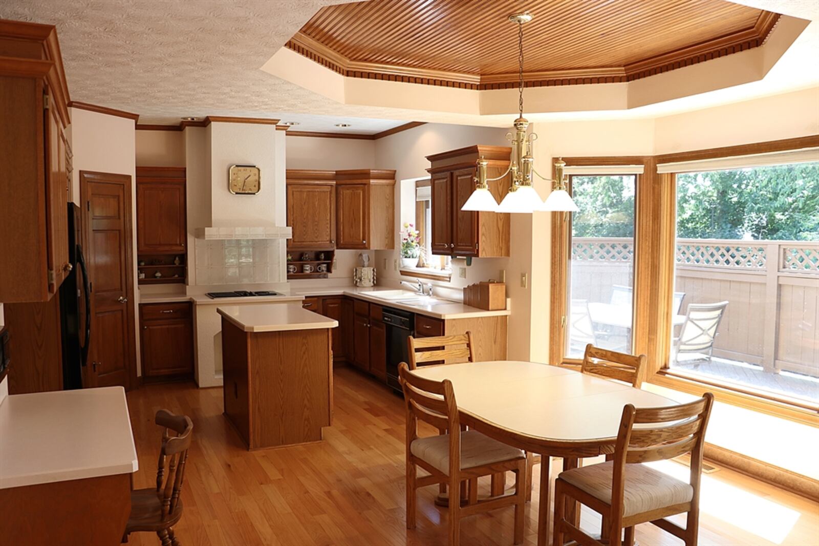 Oak cabinetry wraps around the kitchen area and an island offers additional storage and workspace. 