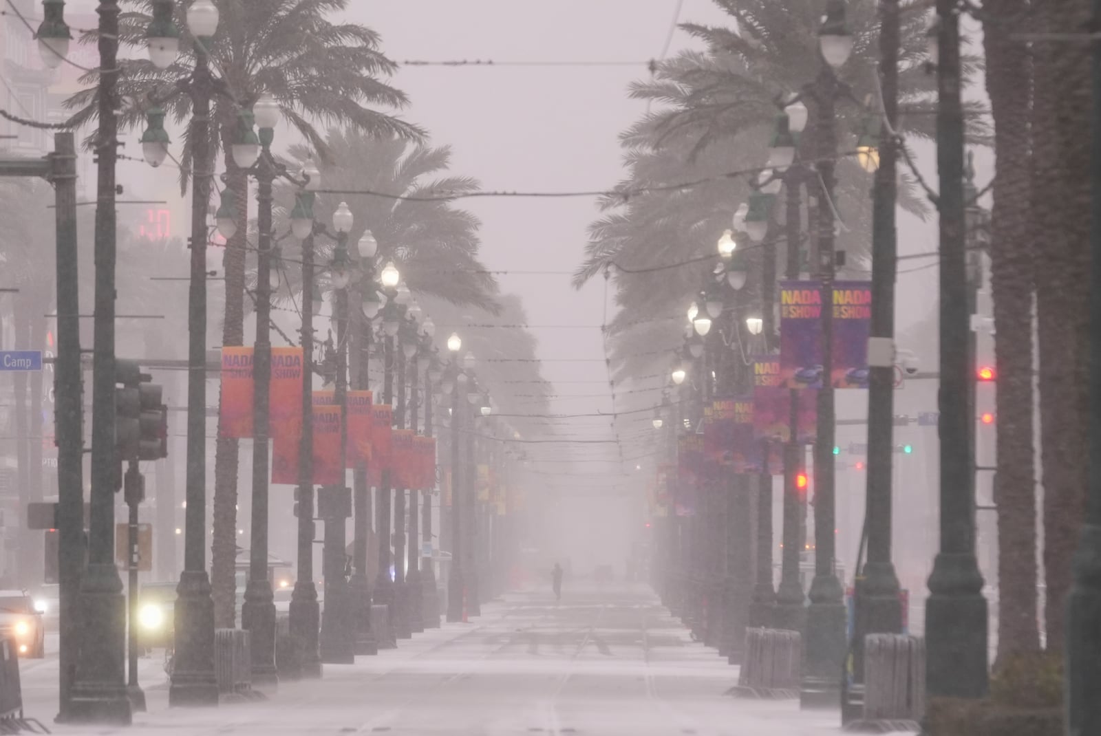 Snow covers Canal Street in downtown New Orleans, Tuesday, Jan. 21, 2025. (AP Photo/Gerald Herbert)