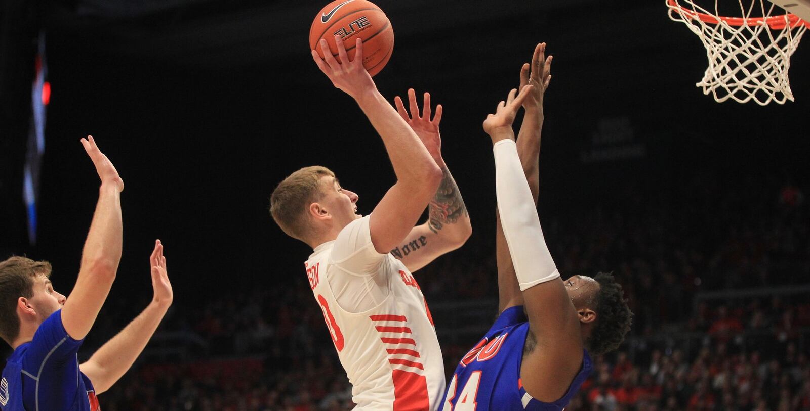 Dayton’s Chase Johnson scores against Houston Baptist on Tuesday, Dec. 3, 2019, at UD Arena. David Jablonski/Staff