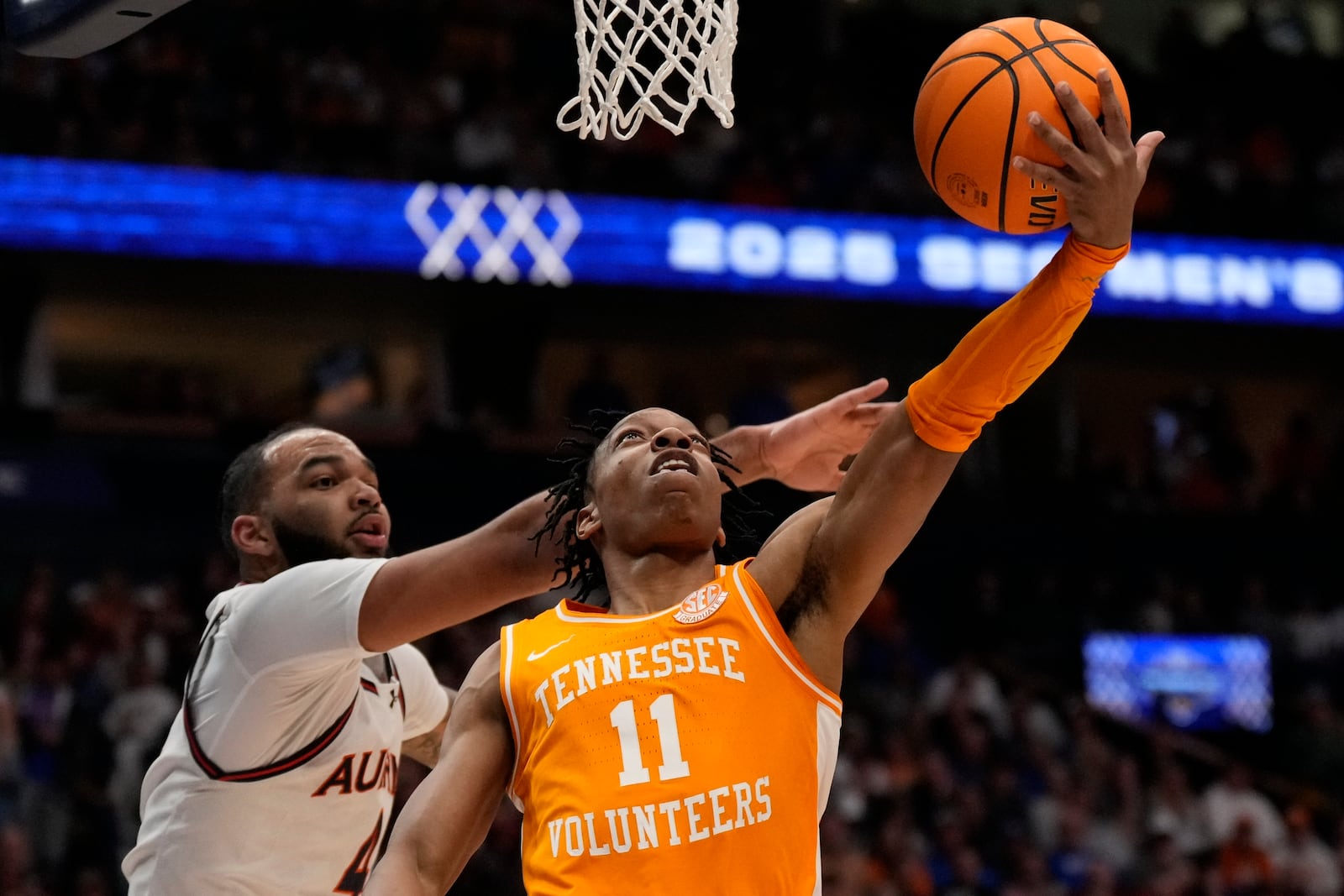 Tennessee guard Jordan Gainey (11) shoots against Auburn forward Johni Broome (4) during the first half of an NCAA college basketball game in the semifinal round of the Southeastern Conference tournament, Saturday, March 15, 2025, in Nashville, Tenn. (AP Photo/George Walker IV)