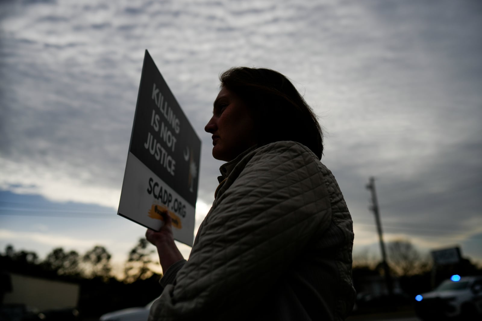 Sawyer Baker protests the execution of South Carolina inmate Brad Sigmon, Friday, March 7, 2025, in Columbia, S.C. (AP Photo/Chris Carlson)