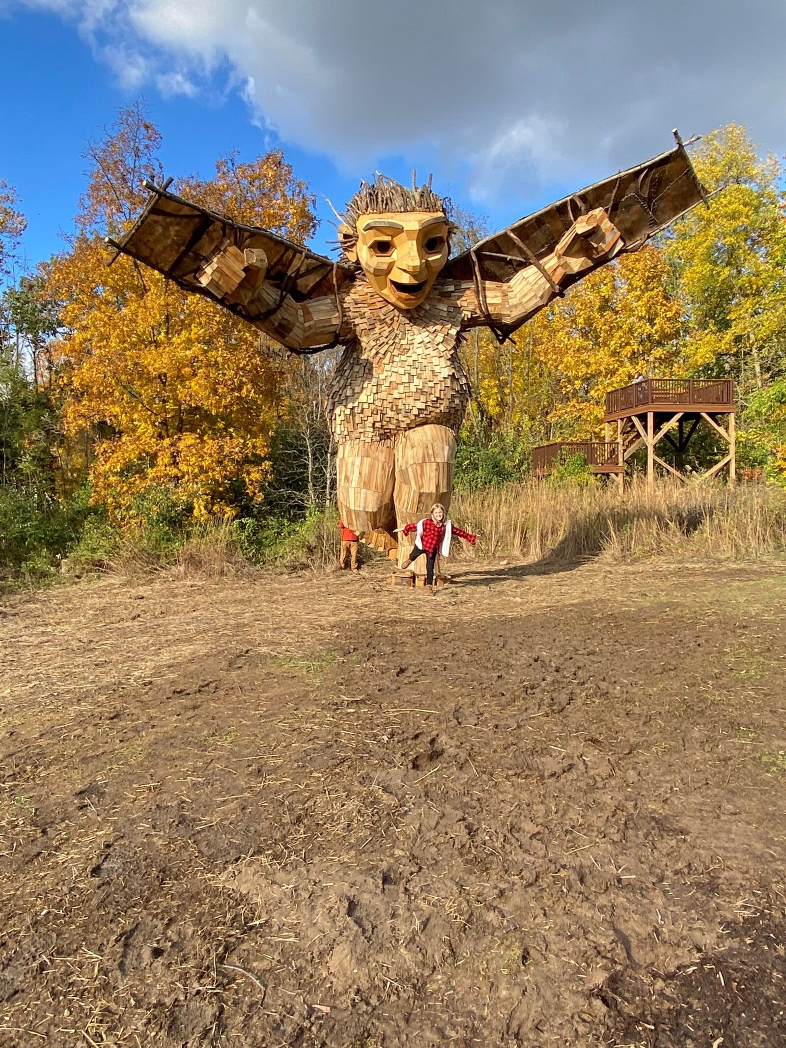 Piper Buirley, 8, pretends to fly like Bibi, the daughter in a giant troll exhibit at Aullwood Audubon Center and Farm in Dayton. Danish artist Thomas Dambo created the installation. CONTRIBUTED