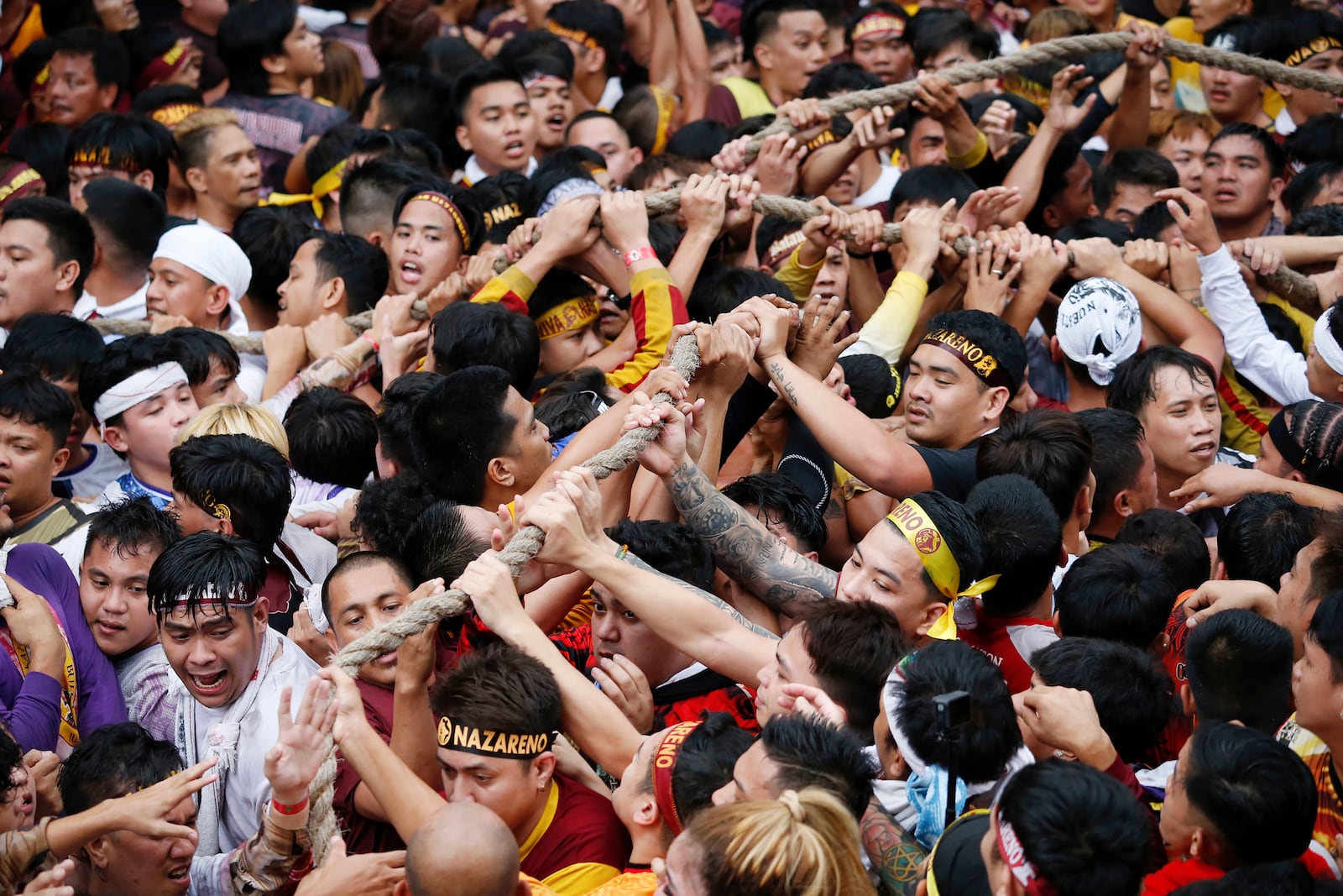 Devotees grab the rope as they pull a glass-covered carriage carrying the image of Jesus Nazareno during its annual procession in Manila, Philippines Thursday, Jan. 9, 2025. (AP Photo/Basilio Sepe)