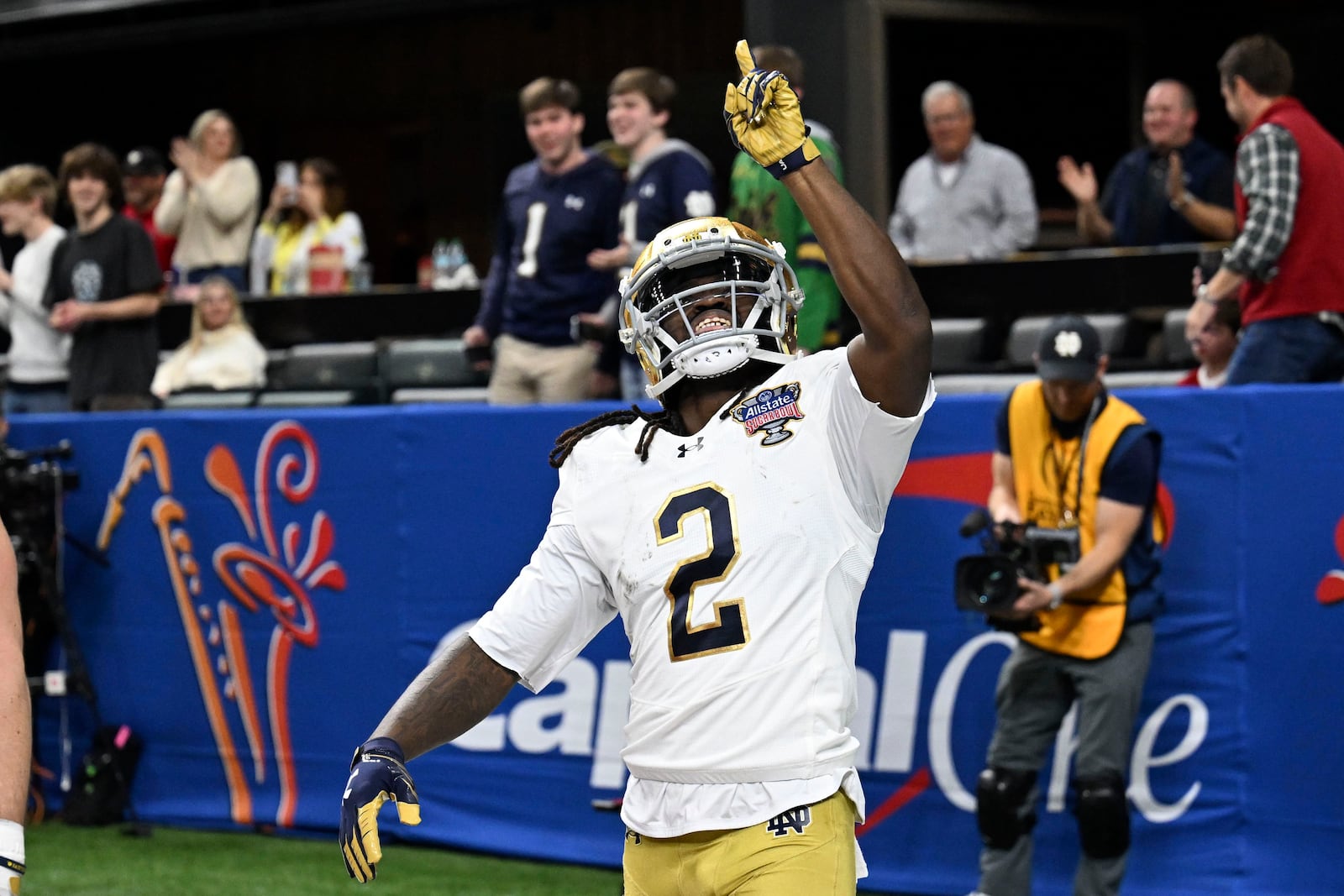 Notre Dame's Jayden Harrison (2) celebrates after returning a kickoff 98 yards for a touchdown during the second half against Georgia in the quarterfinals of a College Football Playoff, Thursday, Jan. 2, 2025, in New Orleans. (AP Photo/Matthew Hinton)