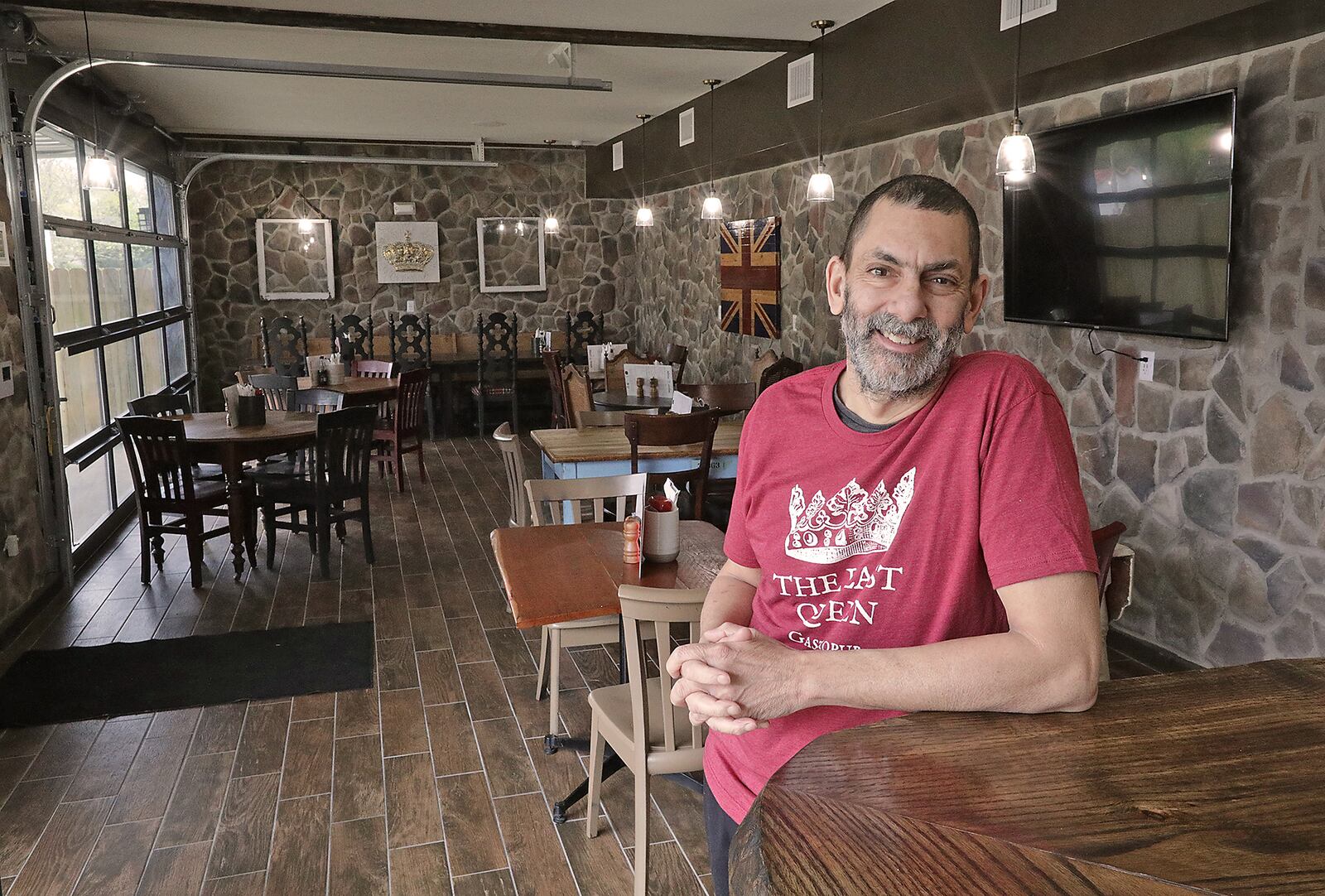 Adrian Shergill, the owner of The Last Queen gastropub, has created the look and feeling of a British pub in Enon. From the food to the decor and even the smell of fish-n-chips cooking transports customers across the sea. BILL LACKEY/STAFF