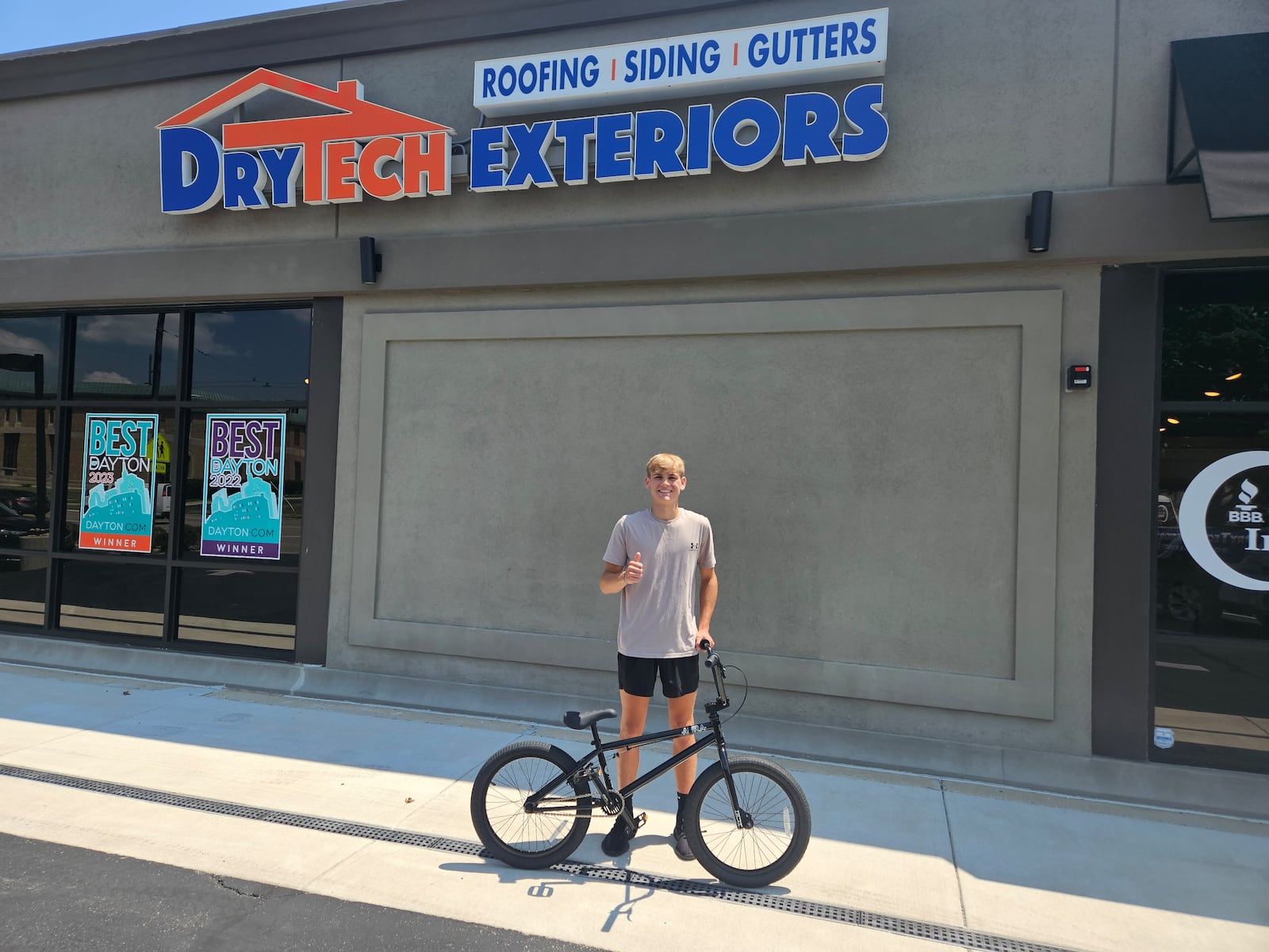 Jonah Shreves with his new bike in front of Drytech Exteriors. JESSICA GRAUE/CONTRIBUTED