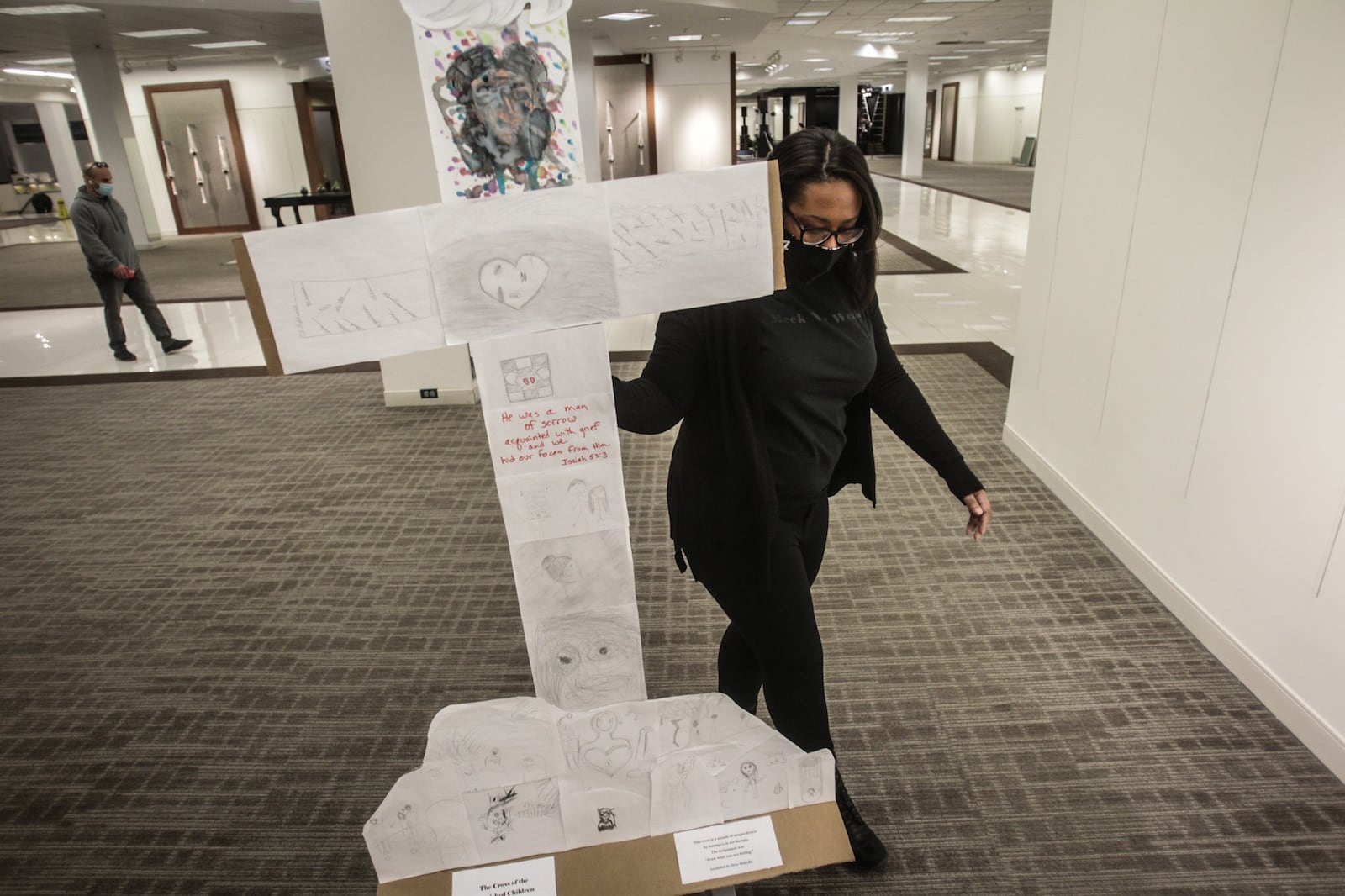 Mosaic Church online worship director, D.J. Shorter sets-up the stations of the cross in the old Elder Beerman Store at  the Fairfield Commons Mall Thursday morning. The church moved into the closed retail space because of the size of the space for COVID-19 distancing. JIM NOELKER/STAFF