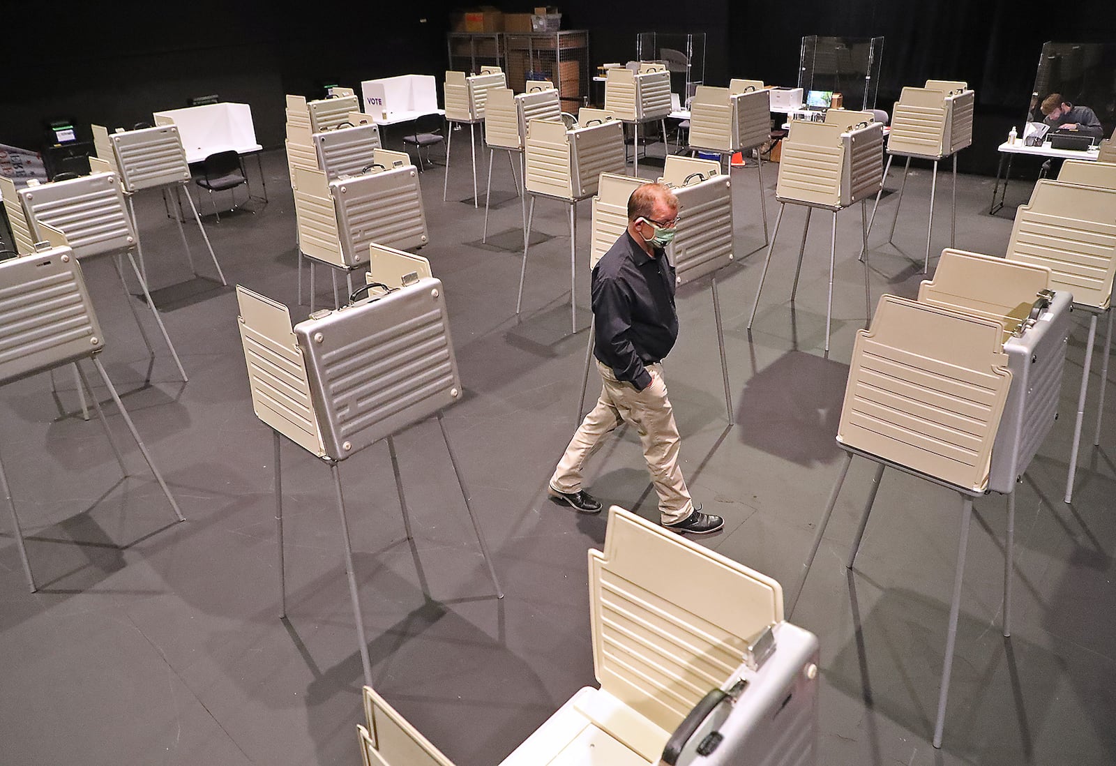 Jason Baker, director of the Clark County Board of Elections, walks through the privacy booths that have been set up in Clark State's Turner Studio Theater. BILL LACKEY/STAFF