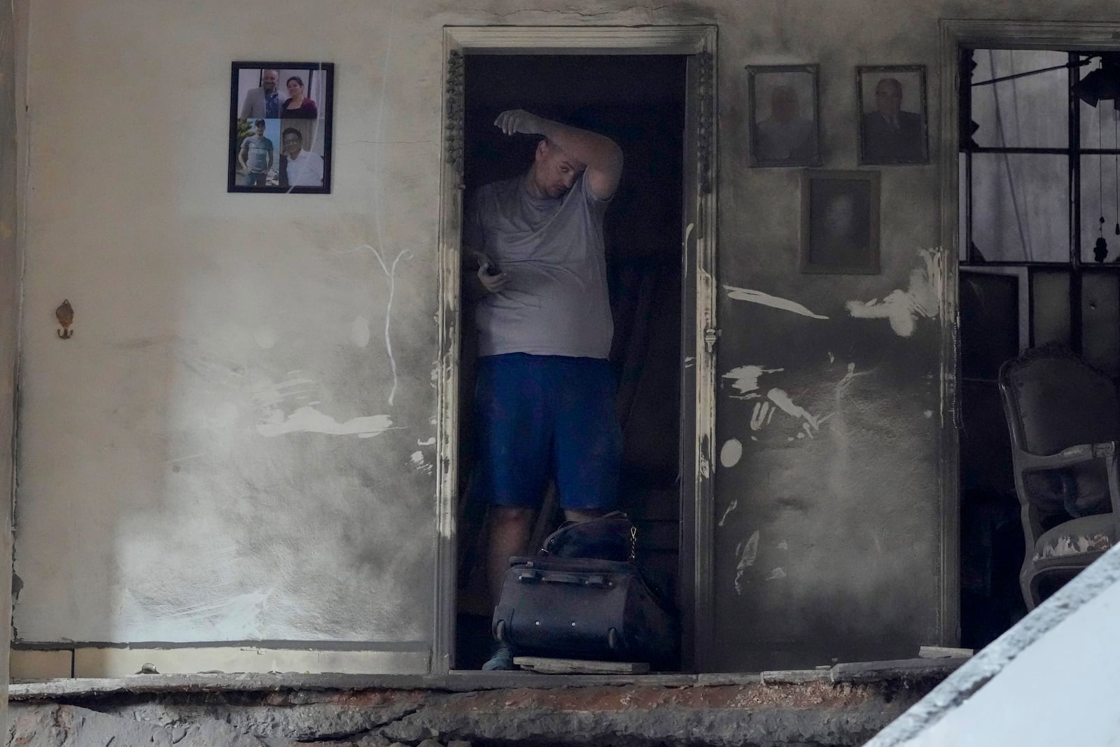 A resident of a building damaged in an Israeli airstrike returns to collect his family's belongings at the site of Thursday's Israeli airstrike in Beirut, Lebanon, Friday, Oct. 11, 2024. (AP Photo/Hassan Ammar)