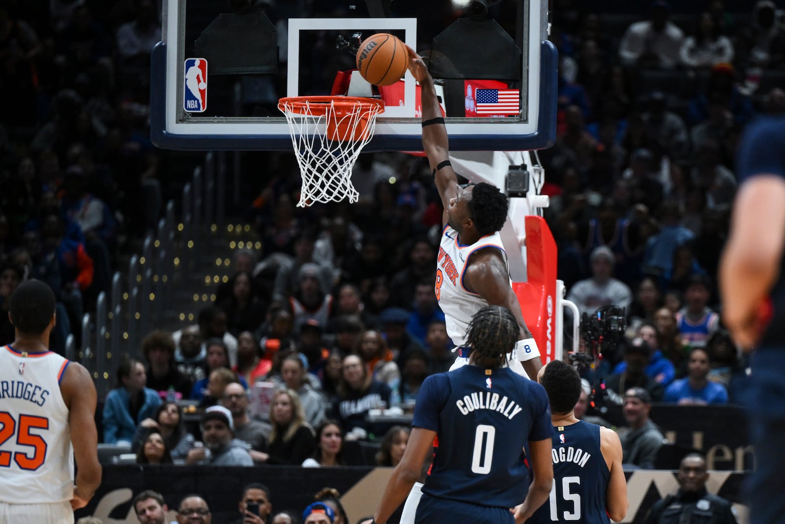 New York Knicks forward OG Anunoby (8) dunks the ball during the first half of an NBA basketball game against the Washington Wizards, Saturday, Dec. 28, 2024, in Washington. (AP Photo/Terrance Williams)