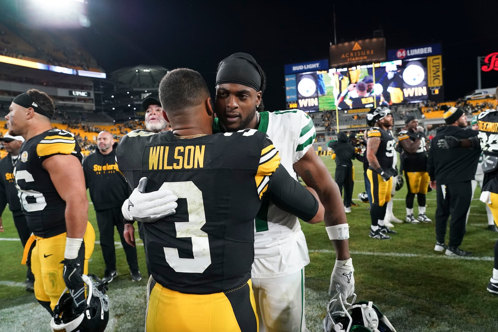 Pittsburgh Steelers quarterback Russell Wilson (3) greets New York Jets wide receiver Davante Adams after an NFL football game in Pittsburgh, Sunday, Oct. 20, 2024. The Steelers won 37-15. (AP Photo/Matt Freed)