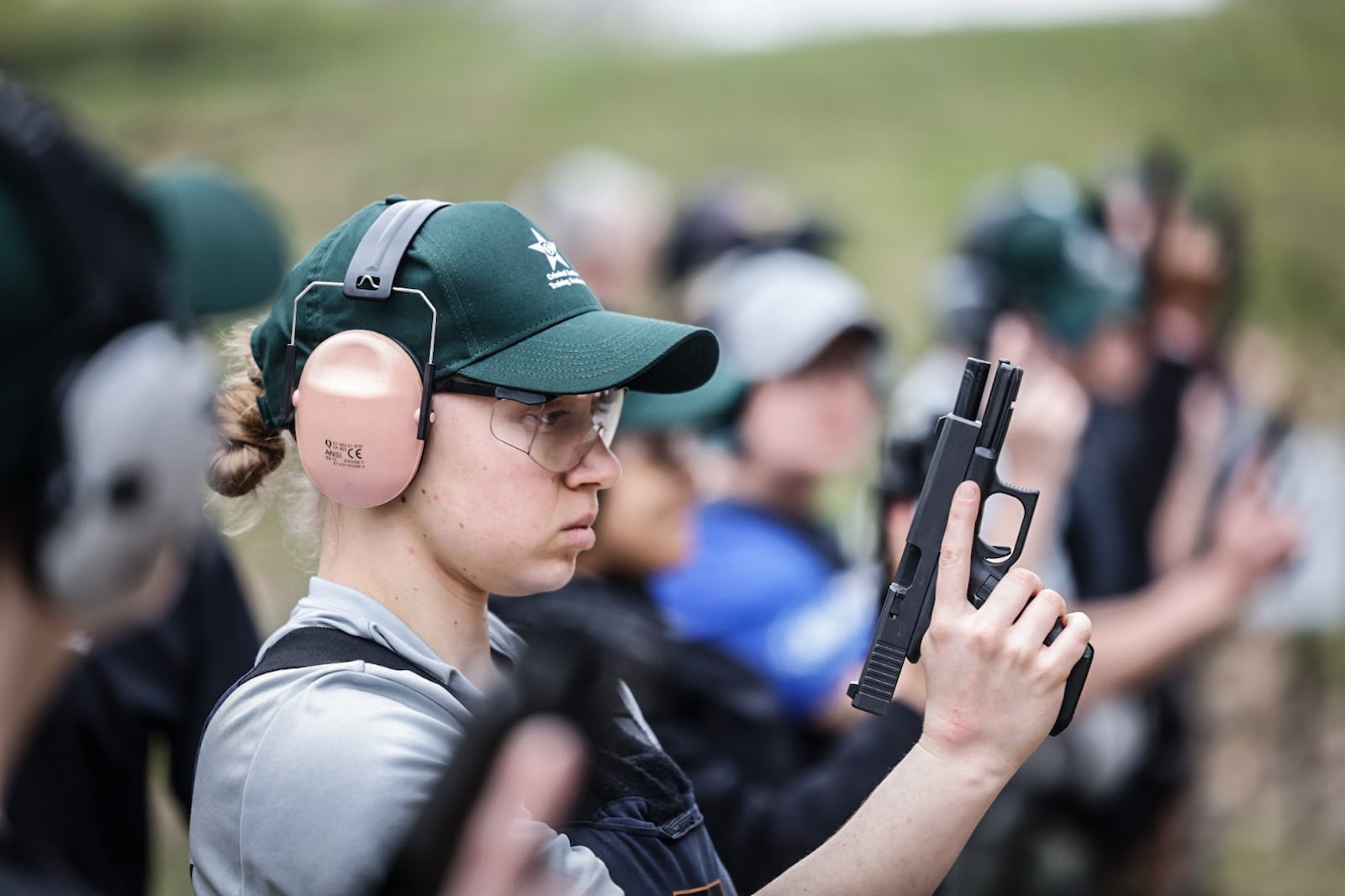 Dayton Daily News reporter London Bishop gets ready to shoot during training at the gun range. JIM NOELKER/STAFF