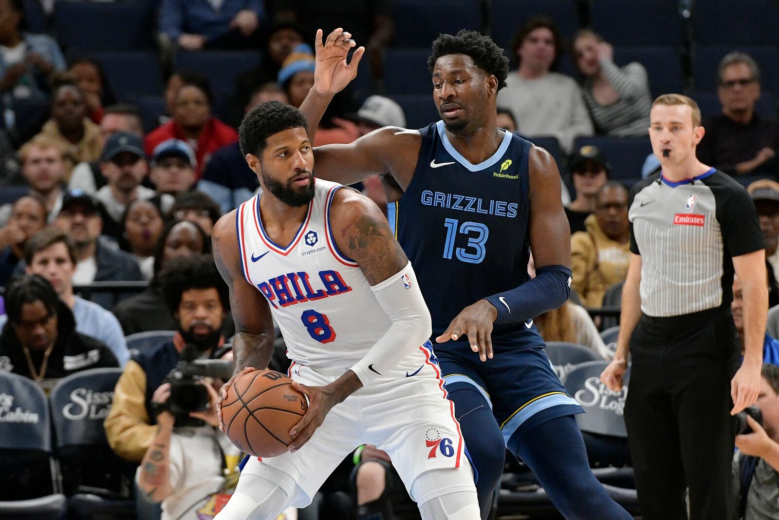 Philadelphia 76ers forward Paul George (8) handles the ball against Memphis Grizzlies forward Jaren Jackson Jr. (13) in the first half of an NBA basketball game Wednesday, Nov. 20, 2024, in Memphis, Tenn. (AP Photo/Brandon Dill)