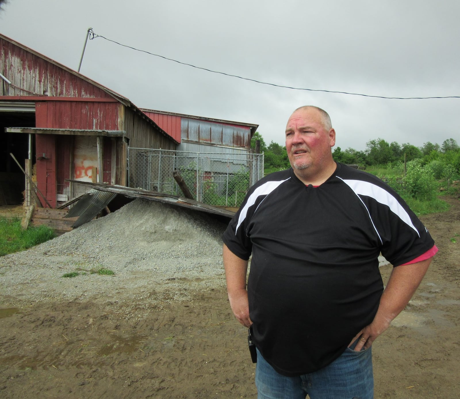 Jeff Barr, at the farm owned by his parents, James and Mary Ann Barr, at 1045 Ludlow Road in Beavercreek Township. The farm was hit by last Monday’s tornado and also by a tornado on April 3, 2018. The latest tornado tore off the roof they had had replaced after last year’s tornado and damaged two other buildings, including one that replaced a building badly damaged in 2018. The tornado also damaged the homes of Jeff home and his brother, Ken Barr. Those homes are also located on the 200 acre farm. PHOTOS by Lynn Hulsey