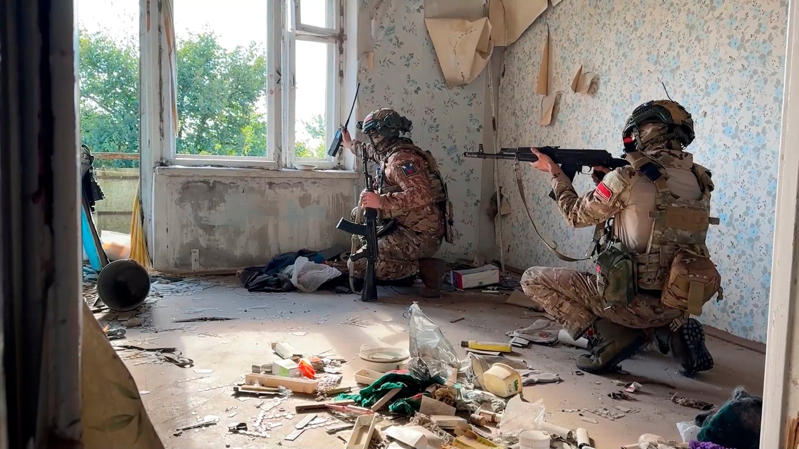 In this photo released by Russian Defense Ministry Press Service on Thursday, Oct. 17, 2024, Russian soldiers signalmen are seen in an apartment building on an undisclosed location in Ukraine. (Russian Defense Ministry Press Service via AP)