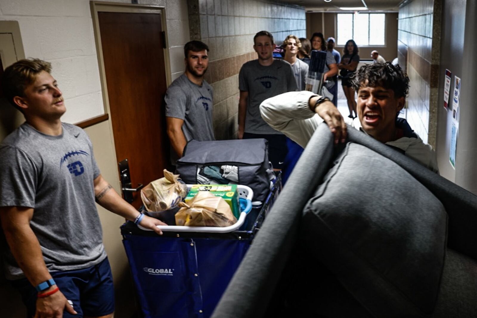 UD freshman Santiago Perez-La Costa moves a large couch down a small hallway at  Marycrest Complex on move-in-day Friday August 16, 2024. Jim Noelker/Staff