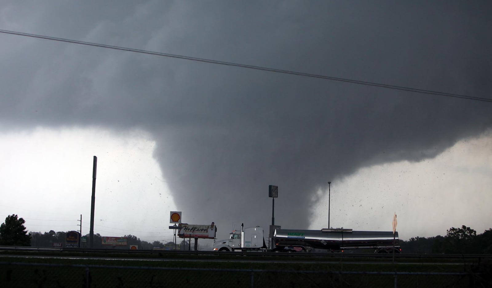 A tornado moves through Tuscaloosa, Ala. Wednesday, April 27, 2011. A wave of severe storms laced with tornadoes strafed the South on Wednesday, killing at least 16 people around the region and splintering buildings across swaths of an Alabama university town. (AP Photo/The Tuscaloosa News, Dusty Compton)