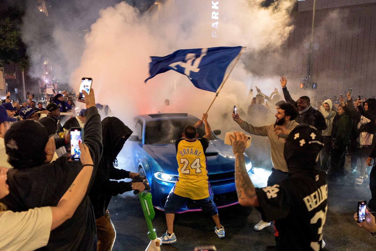 Fans celebrate on the streets after the Los Angeles Dodgers won against the New York Yankees in the baseball World Series Wednesday, Oct. 30, 2024, in downtown Los Angeles. (AP Photo/Damian Dovarganes)