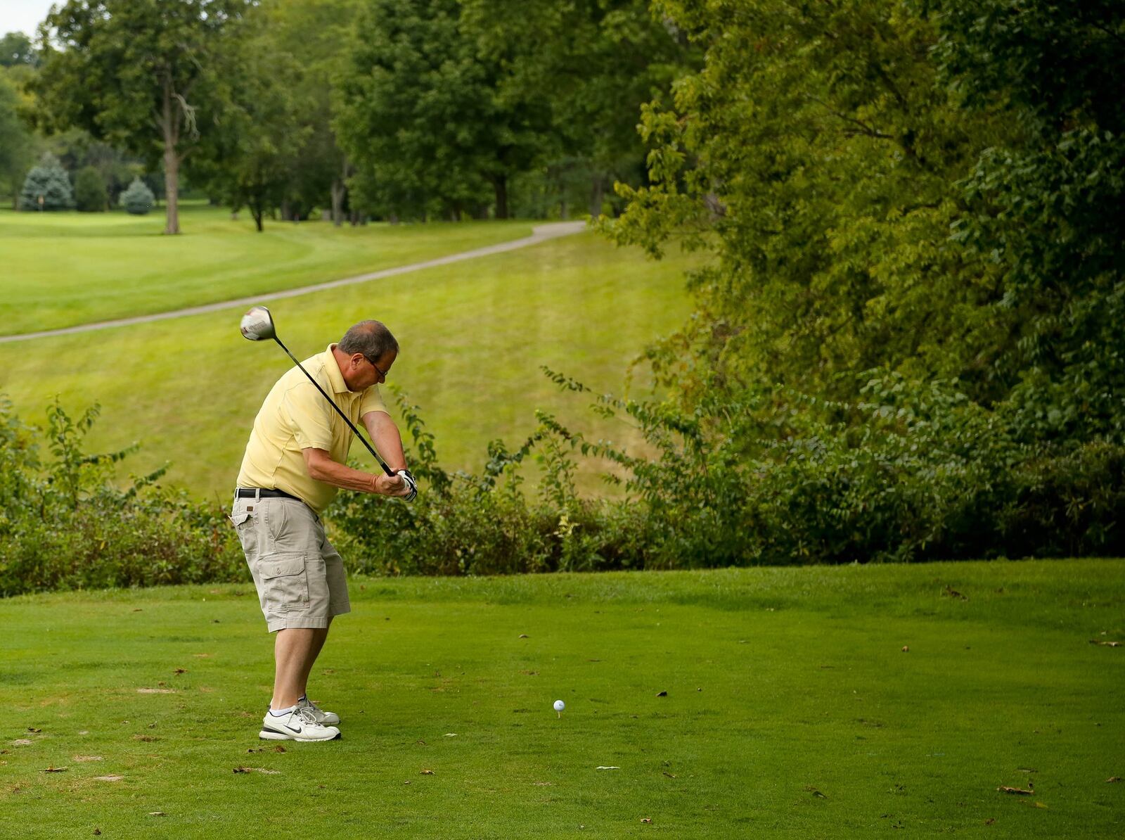 A golfer tees off at Meadowbrook in the years before the 2019 tornadoes hit. STAFF FILE PHOTO / JIM WITMER